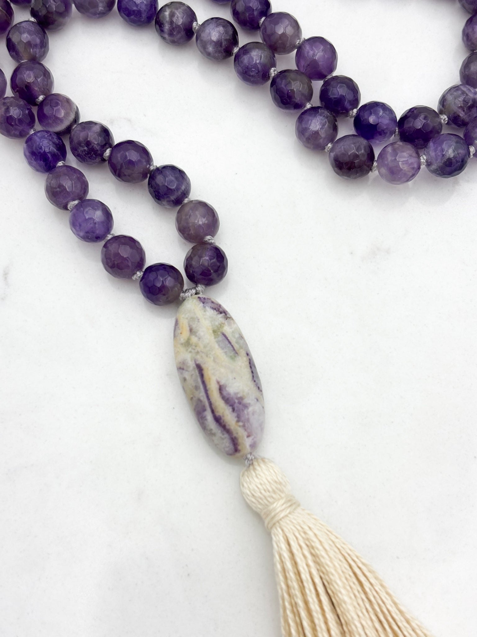 amethyst gemstone mala with chevron amethyst guru bead and cream tassel  | radiant malas | handmade in boulder, colorado