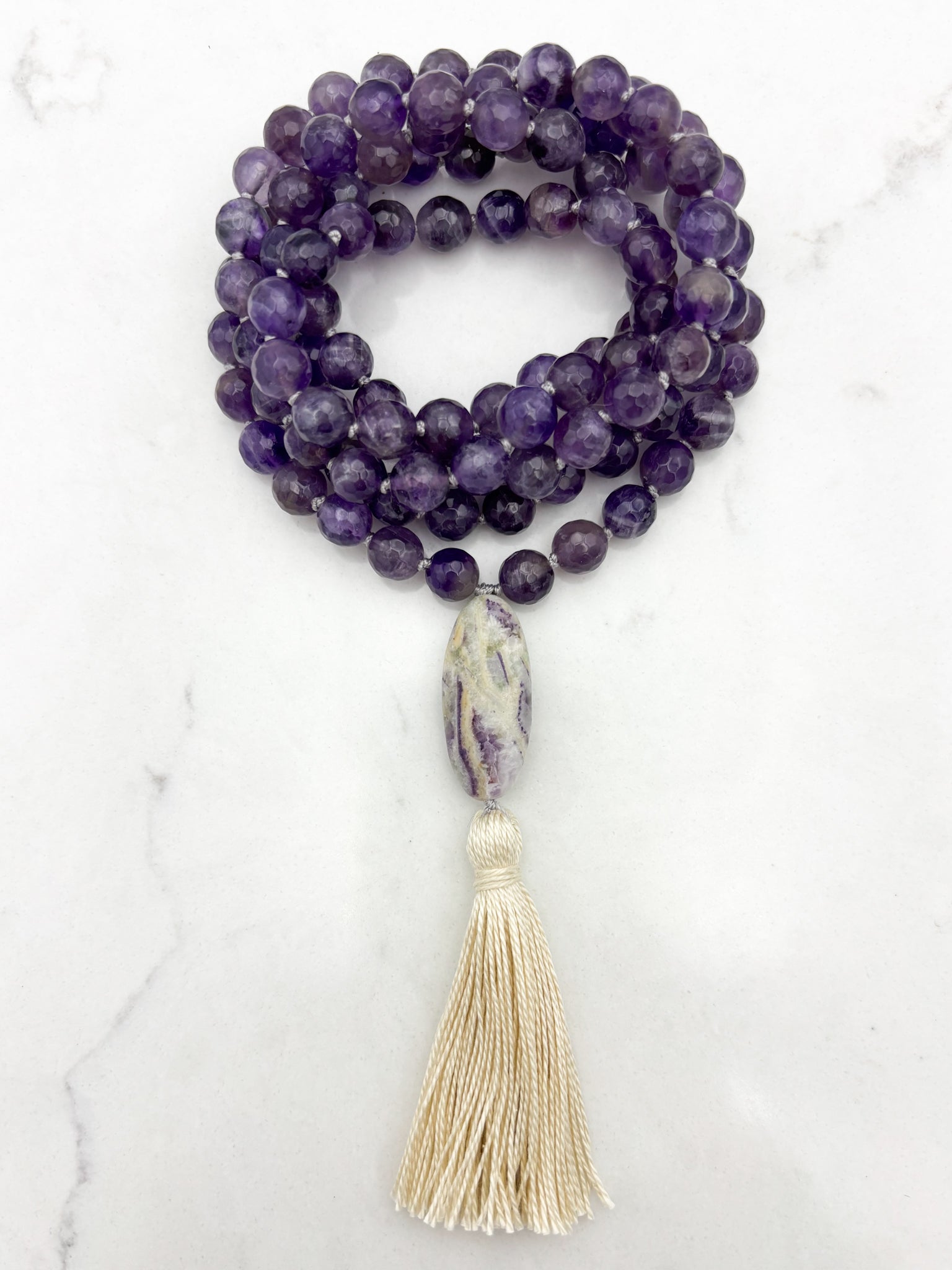 amethyst gemstone mala with chevron amethyst guru bead and cream tassel  | radiant malas | handmade in boulder, colorado
