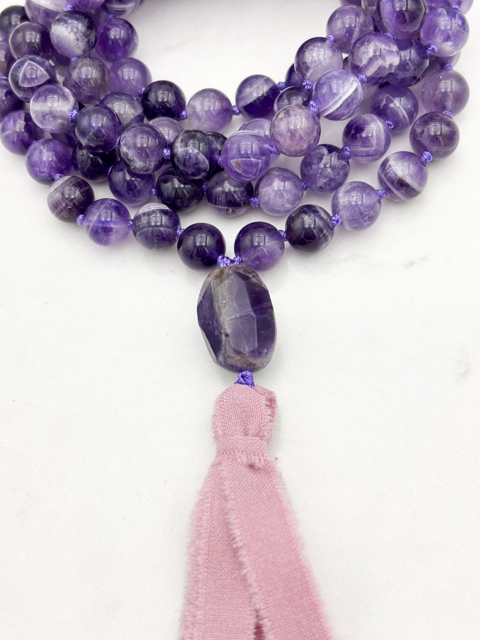 amethyst gemstone mala necklace with amethyst guru bead and pink silk ribbon tassel | radiant malas | handmade in boulder, colorado