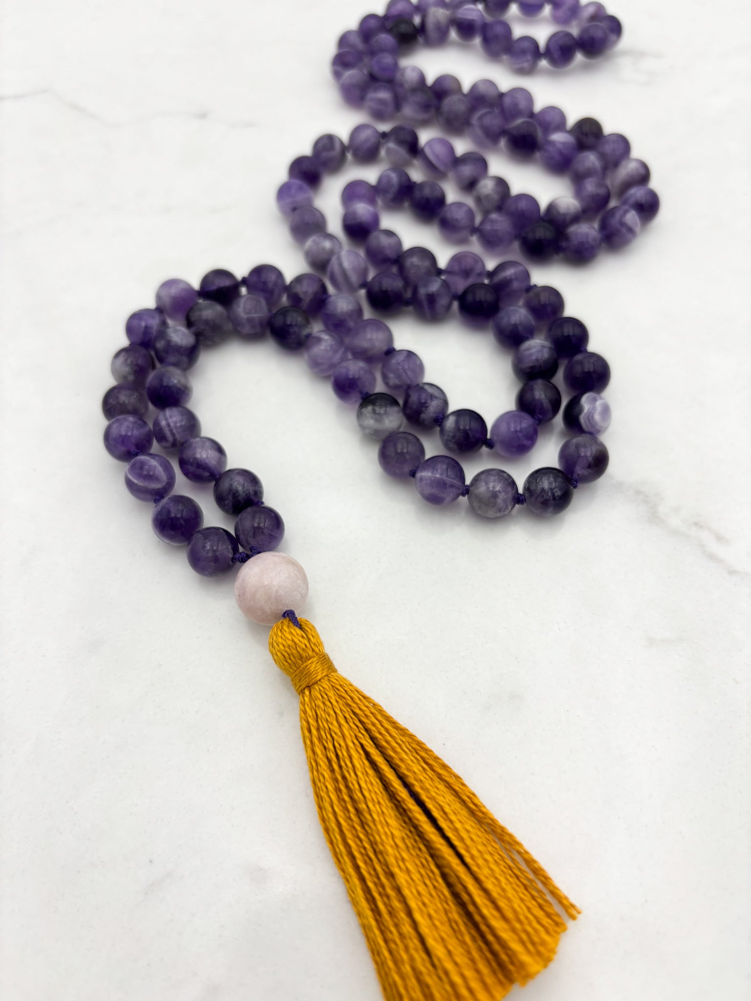 amethyst gemstone mala necklace with kunzite guru bead and gold tassel | radiant malas | handmade in boulder, colorado