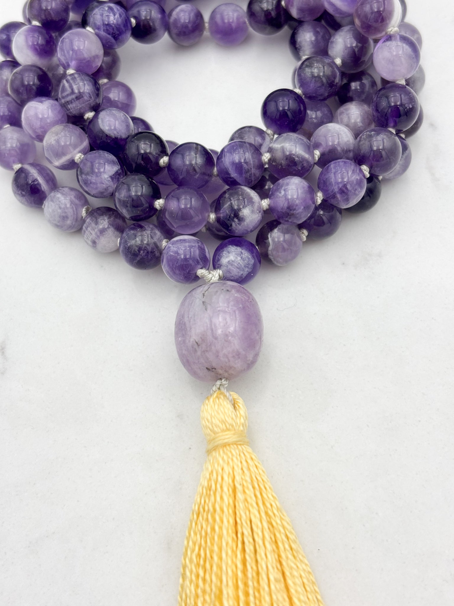 amethyst gemstone mala with lepidolite guru bead and yellow tassel | radiant malas | handmade in boulder, colorado