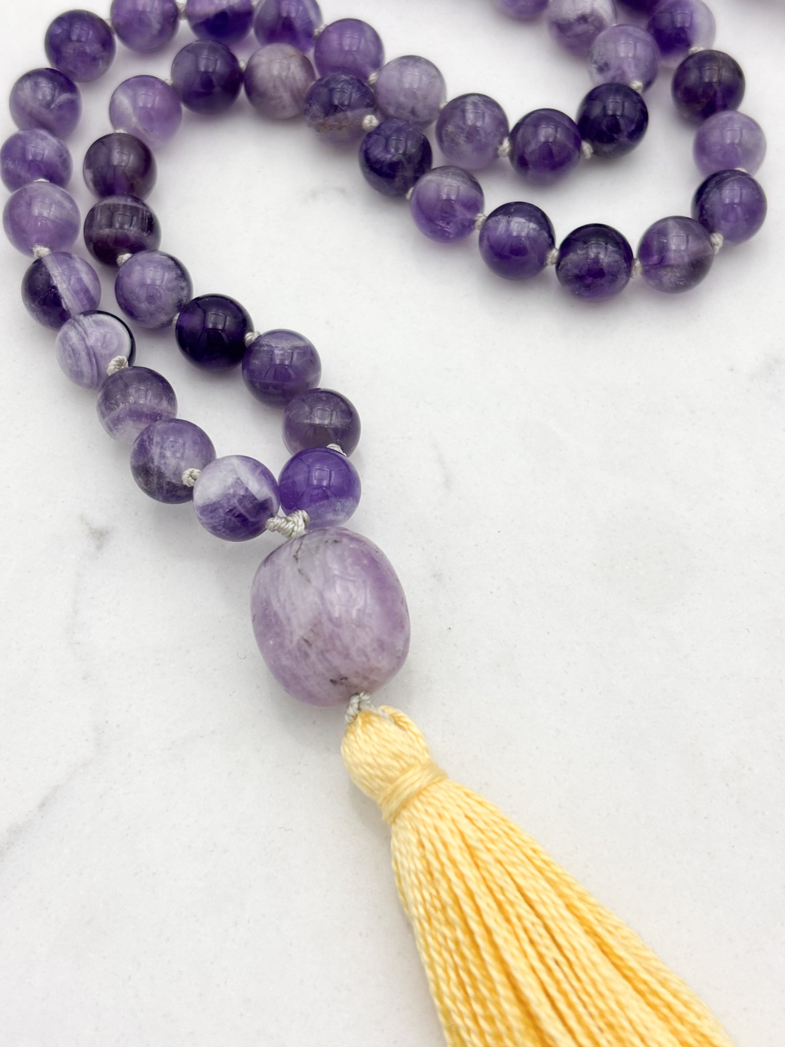 amethyst gemstone mala with lepidolite guru bead and yellow tassel | radiant malas | handmade in boulder, colorado