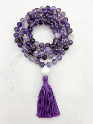 amethyst gemstone mala with carved tridacna shell guru bead and purple tassel | radiant malas | handmade in boulder, colorado