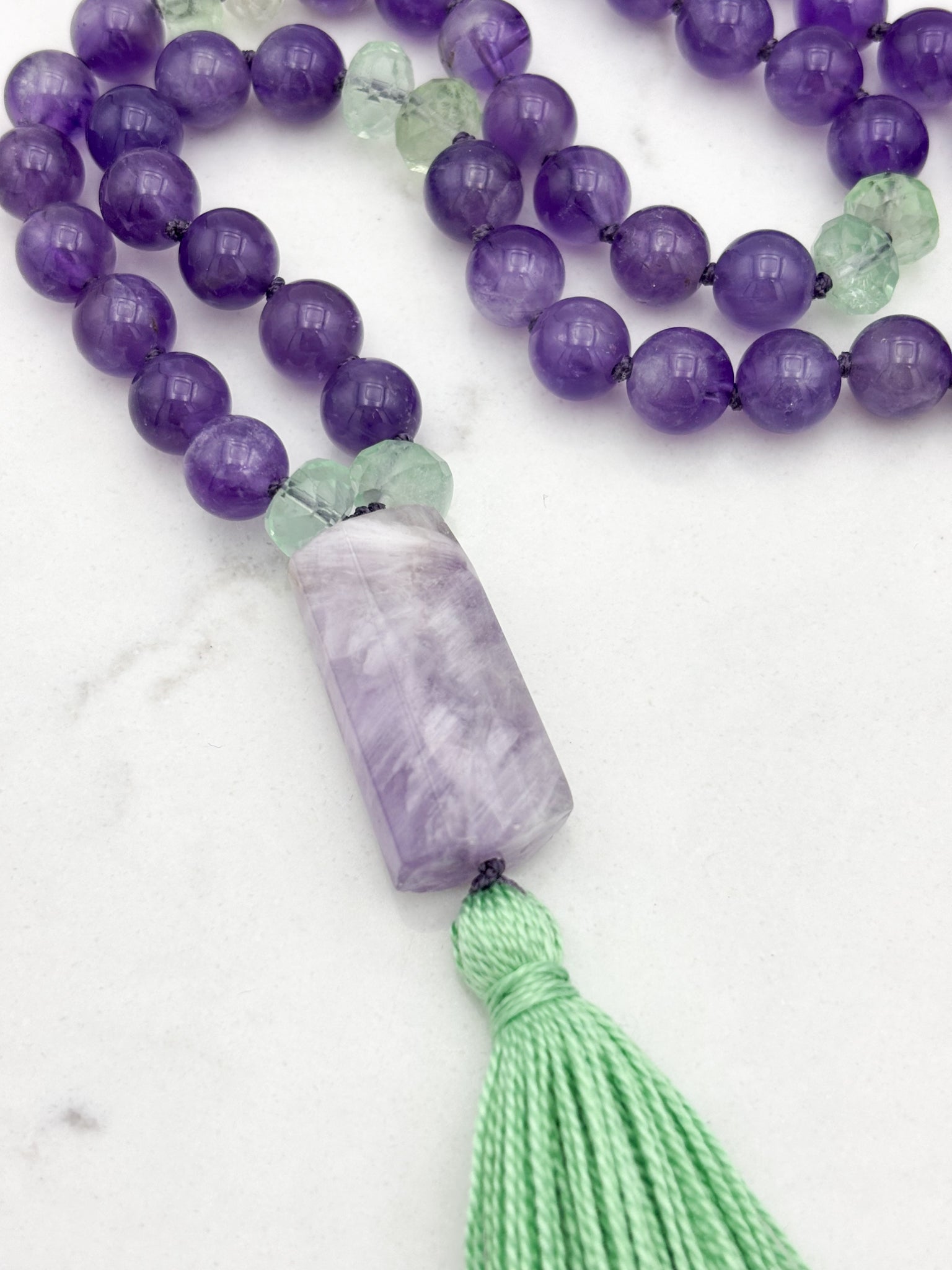 amethyst and fluorite gemstone mala with pink amethyst guru bead and green tassel | radiant malas | handmade in boulder, colorado