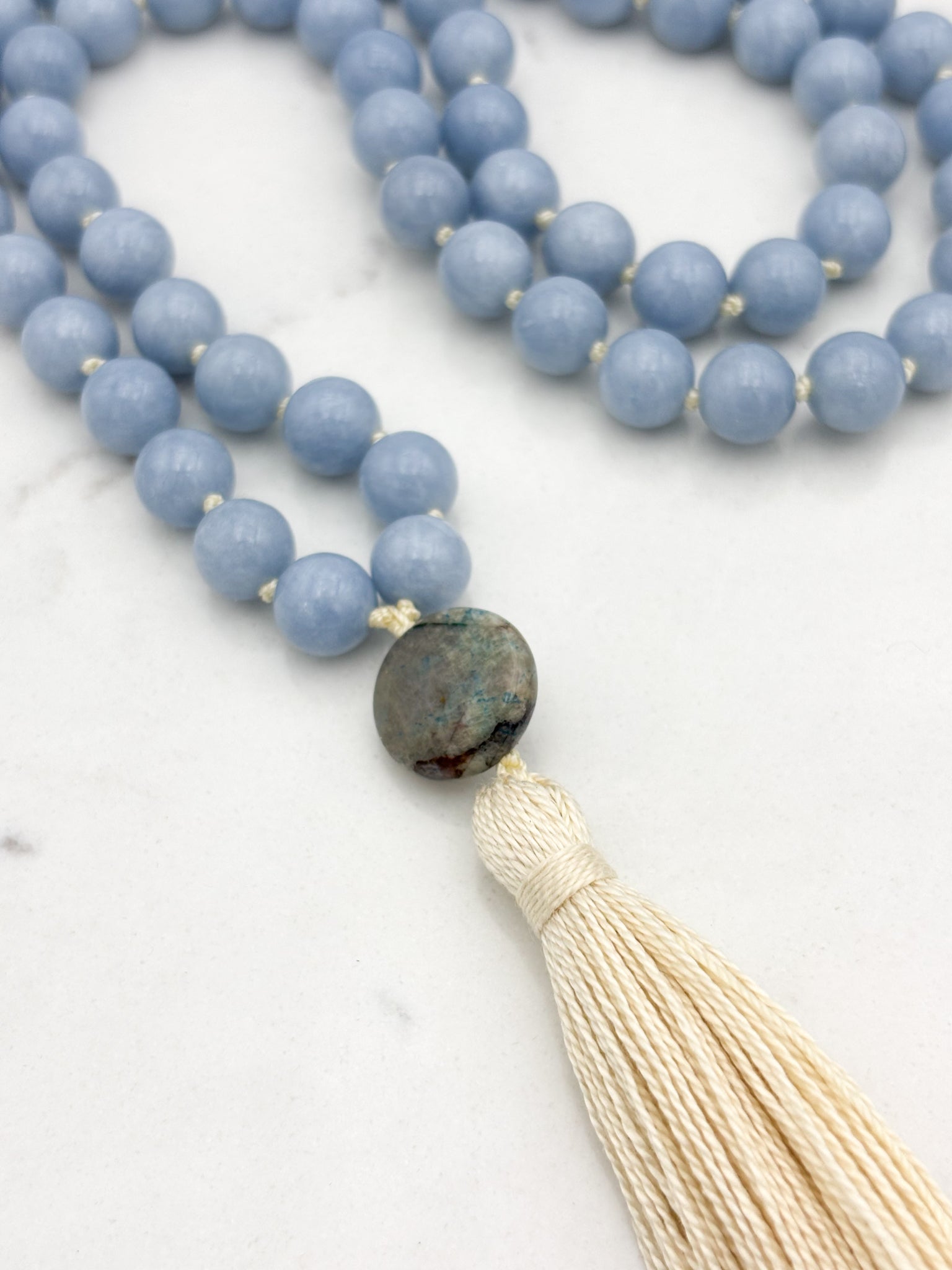 angelite gemstone mala necklace with azurite guru bead and cream colored tassel | radiant malas | handmade in boulder, colorado