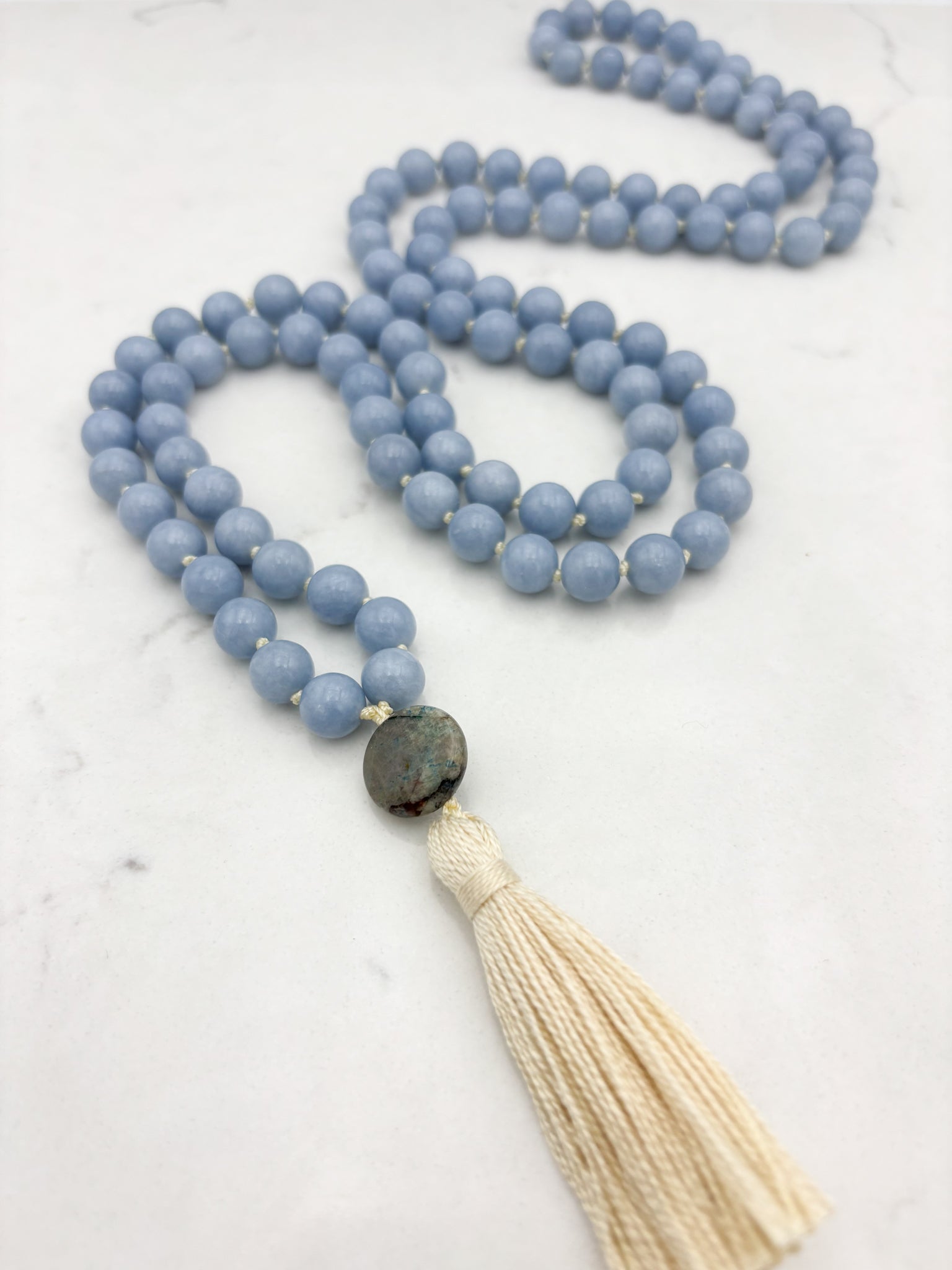 angelite gemstone mala necklace with azurite guru bead and cream colored tassel | radiant malas | handmade in boulder, colorado