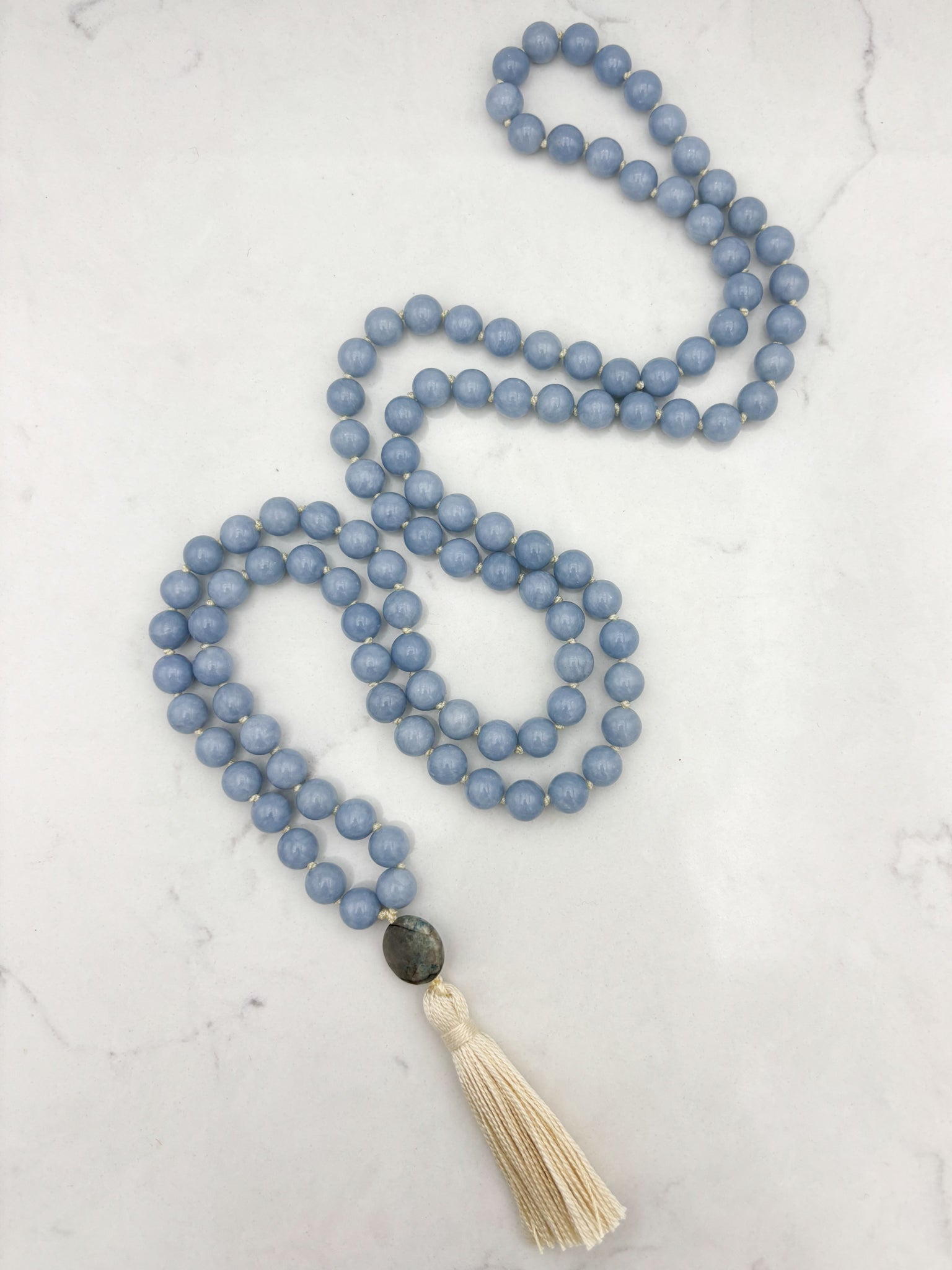 angelite gemstone mala necklace with azurite guru bead and cream colored tassel | radiant malas | handmade in boulder, colorado