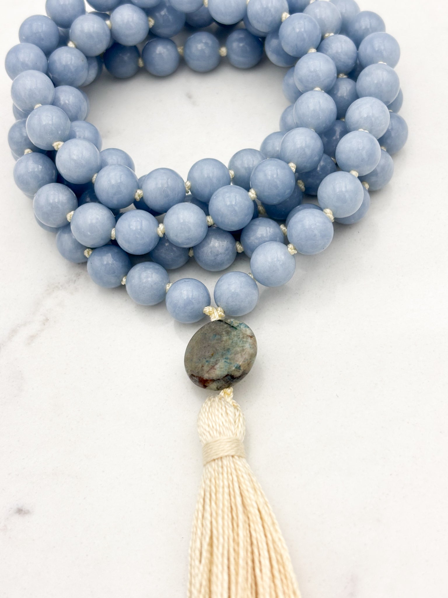 angelite gemstone mala necklace with azurite guru bead and cream colored tassel | radiant malas | handmade in boulder, colorado