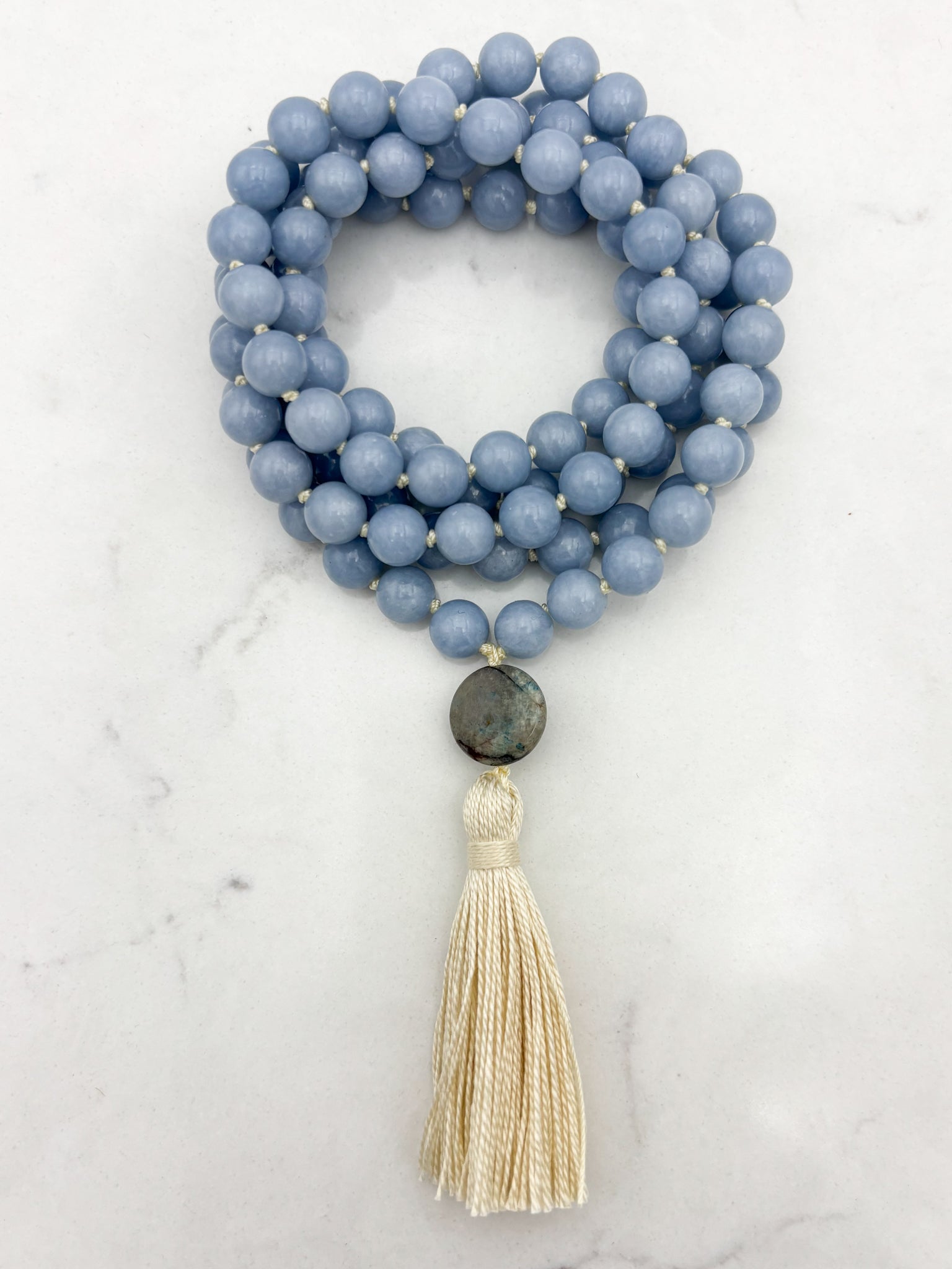 angelite gemstone mala necklace with azurite guru bead and cream colored tassel | radiant malas | handmade in boulder, colorado