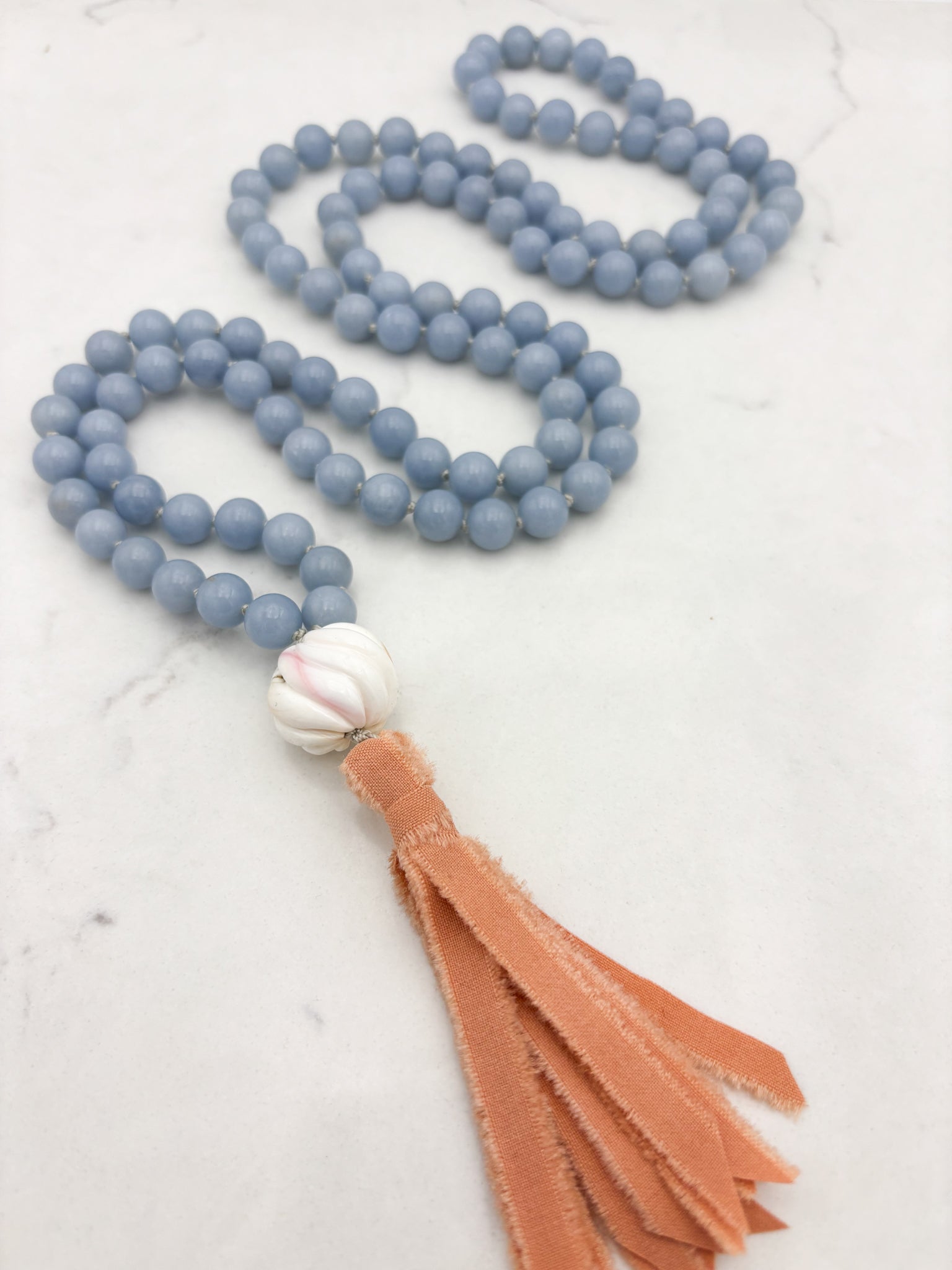 angelite gemstone mala with shell guru bead and peach silk tassel | radiant malas | handmade in boulder, colorado