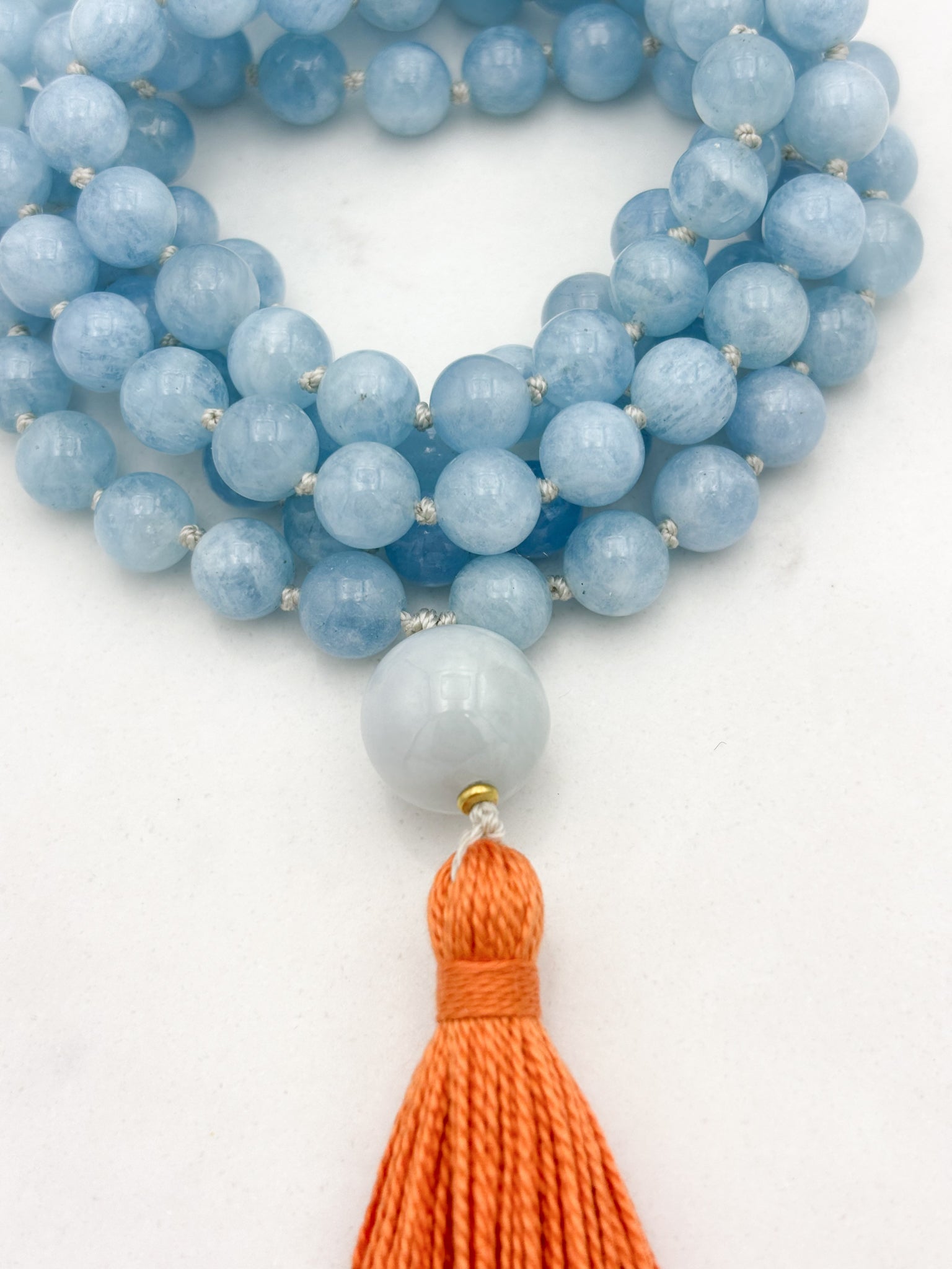 aquamarine gemstone mala with burma jade guru bead and orange tassel | radiant malas | handmade in boulder, colorado
