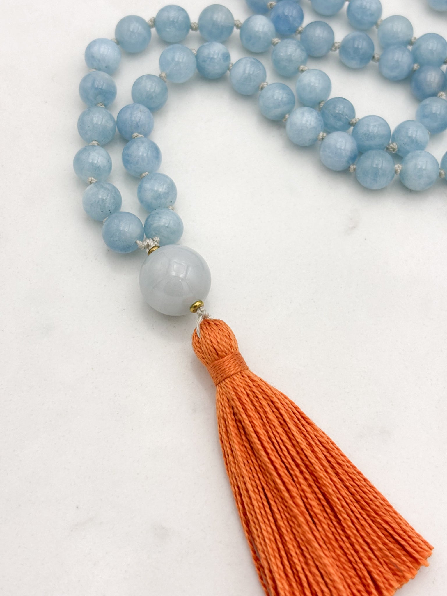 aquamarine gemstone mala with burma jade guru bead and orange tassel | radiant malas | handmade in boulder, colorado