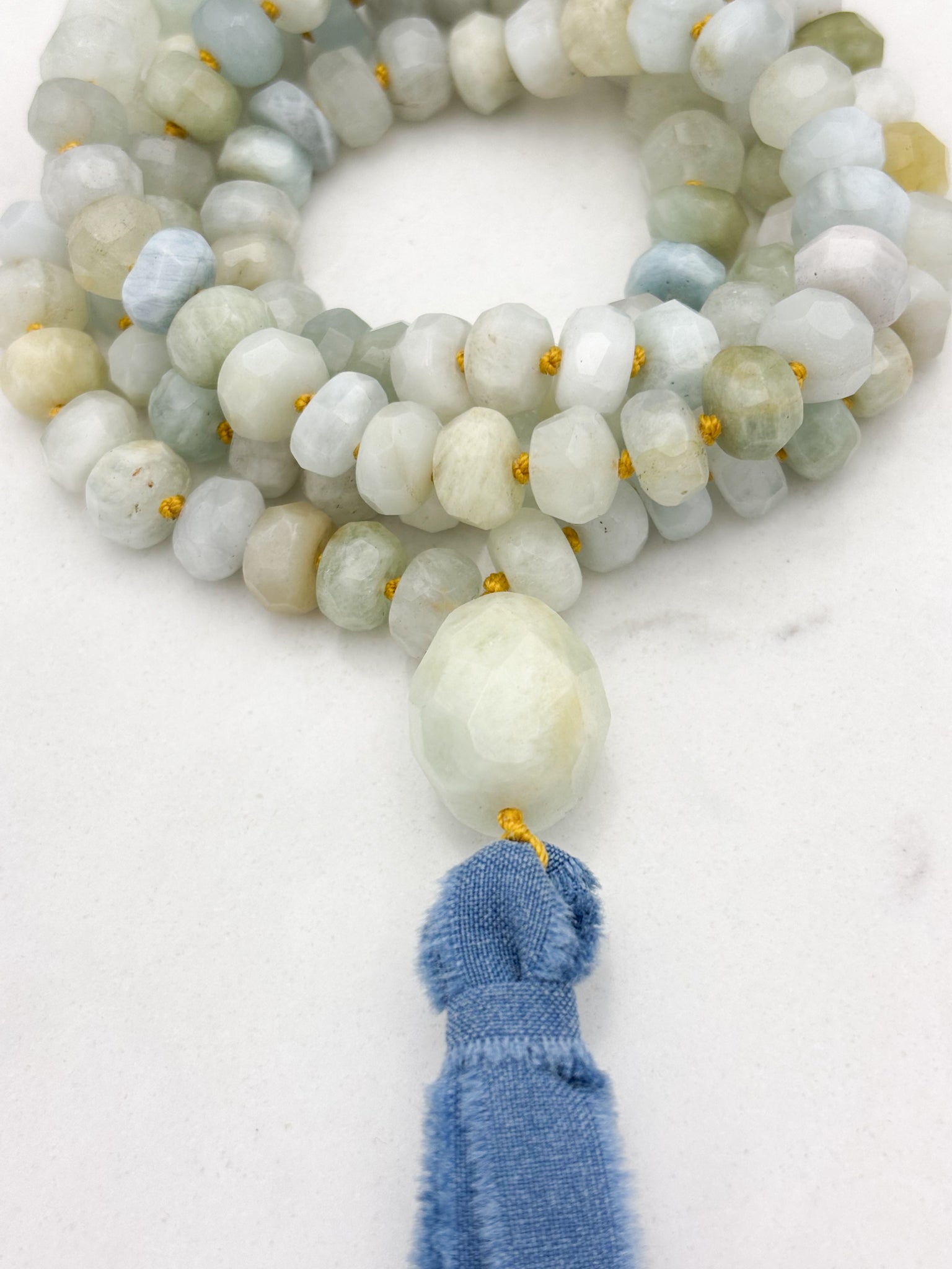 aquamarine gemstone mala with aquamarine guru bead and blue silk ribbon tassel | radiant malas 
 handmade in boulder, colorado
