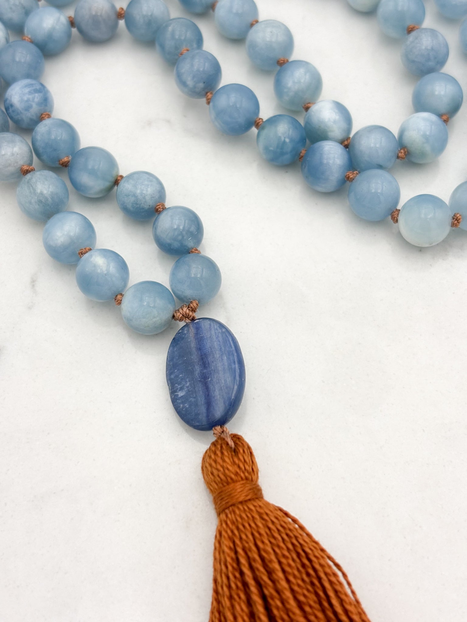 aquamarine gemstone mala with kyanite guru bead and rust colored tassel | radiant malas | handmade in boulder, colorado
