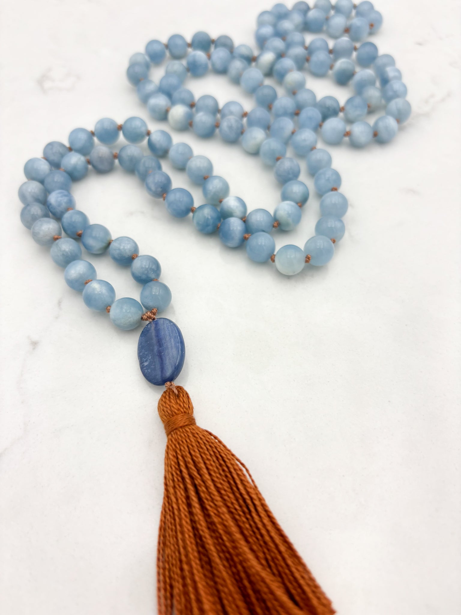 aquamarine gemstone mala with kyanite guru bead and rust colored tassel | radiant malas | handmade in boulder, colorado