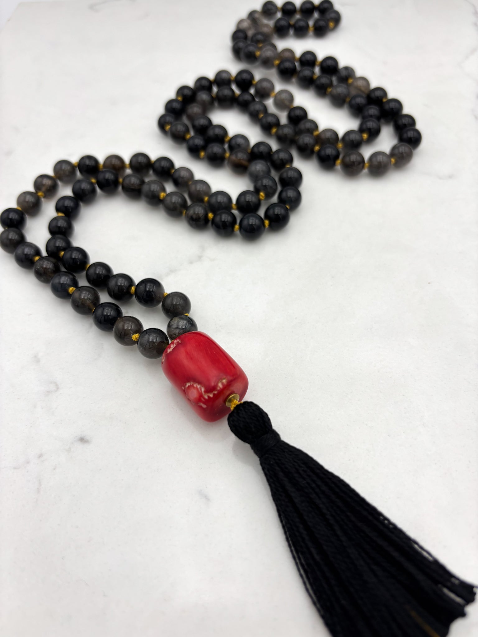black rutile quartz gemstone mala necklace with red coral guru bead and black tassel | radiant malas | handmade in boulder, colorado
