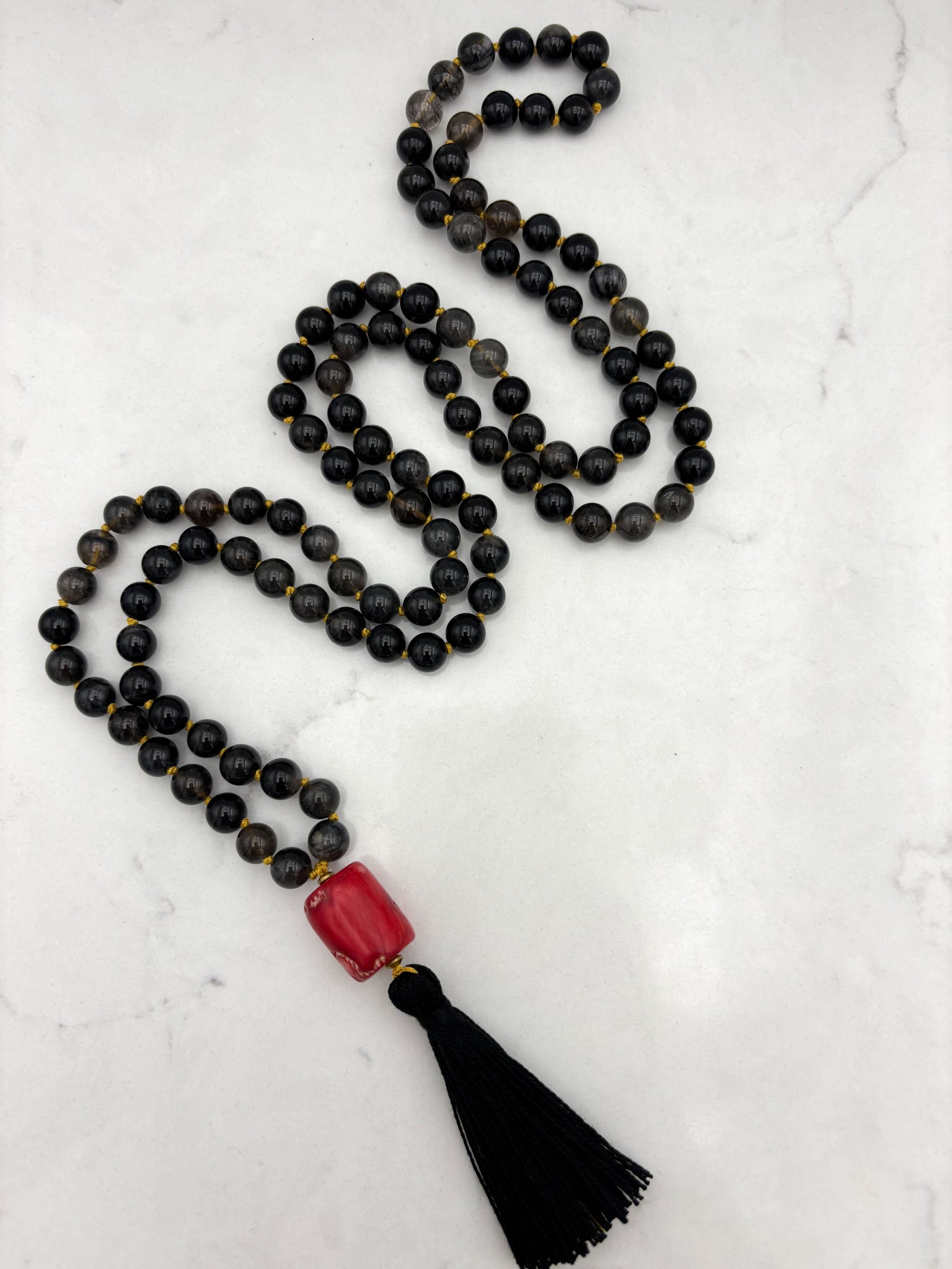 black rutile quartz gemstone mala necklace with red coral guru bead and black tassel | radiant malas | handmade in boulder, colorado