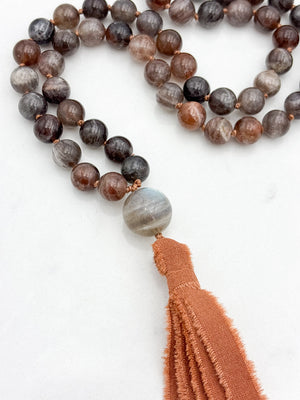 black sunstone gemstone mala with labradorite guru bead and rust colored silk tassel | radiant malas | handmade in boulder, colorado