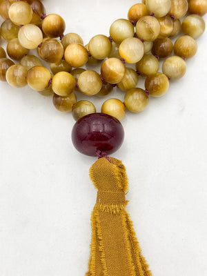 blond tiger's eye gemstone mala necklace with cherry agate guru bead and ochre silk tassel  | radiant malas | handmade in boulder, colorado