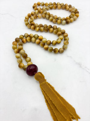 blond tiger's eye gemstone mala necklace with cherry agate guru bead and ochre silk tassel  | radiant malas | handmade in boulder, colorado