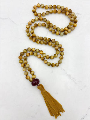 blond tiger's eye gemstone mala necklace with cherry agate guru bead and ochre silk tassel  | radiant malas | handmade in boulder, colorado