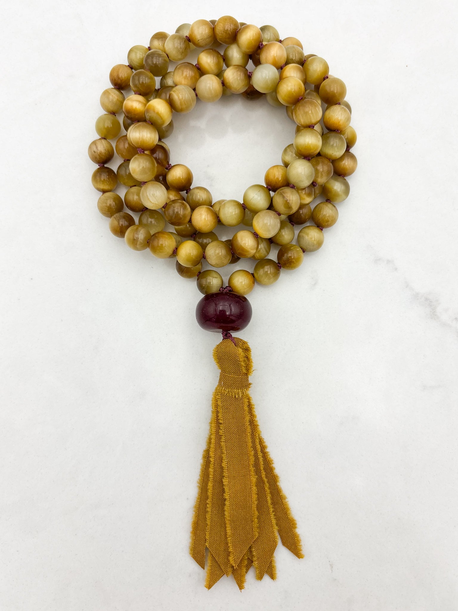 blond tiger's eye gemstone mala necklace with cherry agate guru bead and ochre silk tassel  | radiant malas | handmade in boulder, colorado