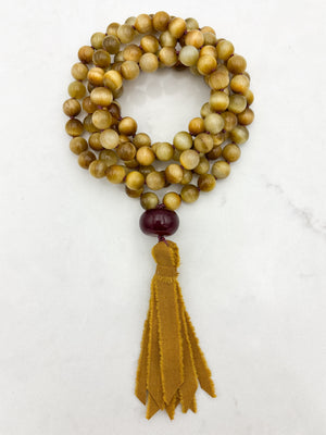 blond tiger's eye gemstone mala necklace with cherry agate guru bead and ochre silk tassel  | radiant malas | handmade in boulder, colorado