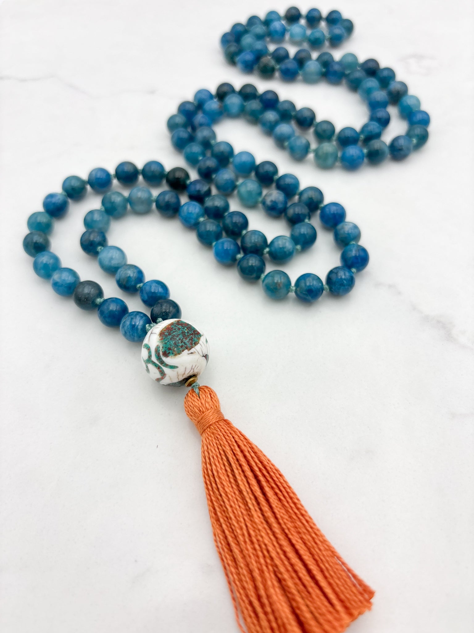 blue apatite gemstone mala with bone turquoise coral guru bead and orange | radiant malas | handmade in boulder, colorado