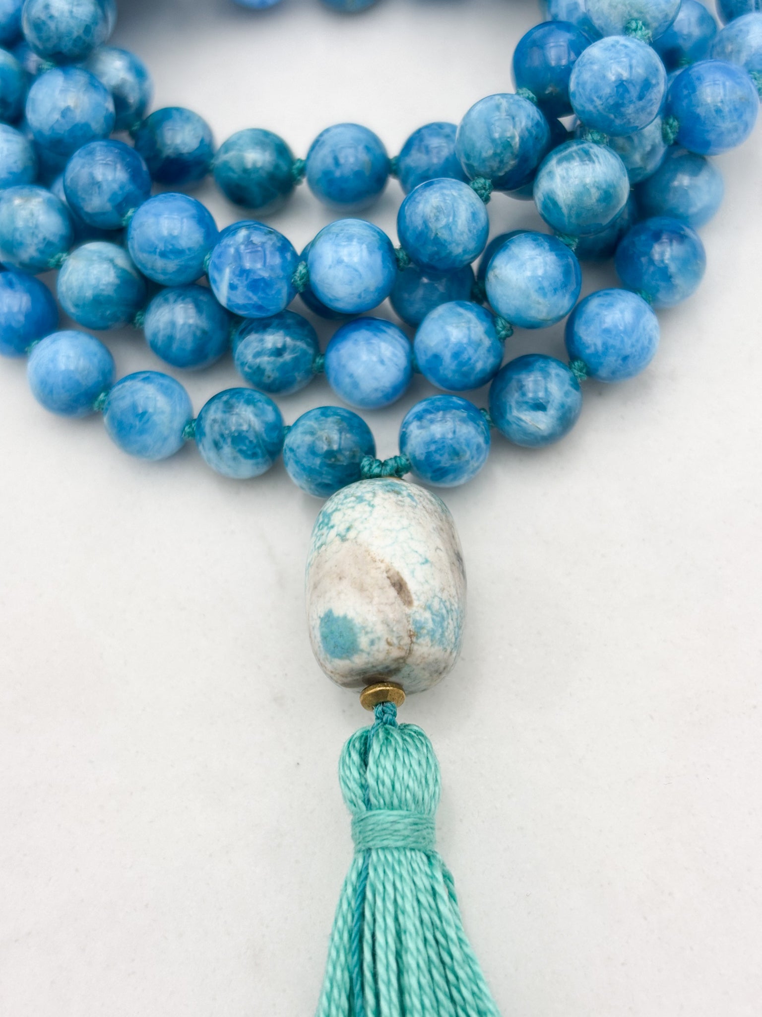 blue apatite gemstone mala with ceramic guru bead and teal tassel | radiant malas | handmade in boulder, colorado