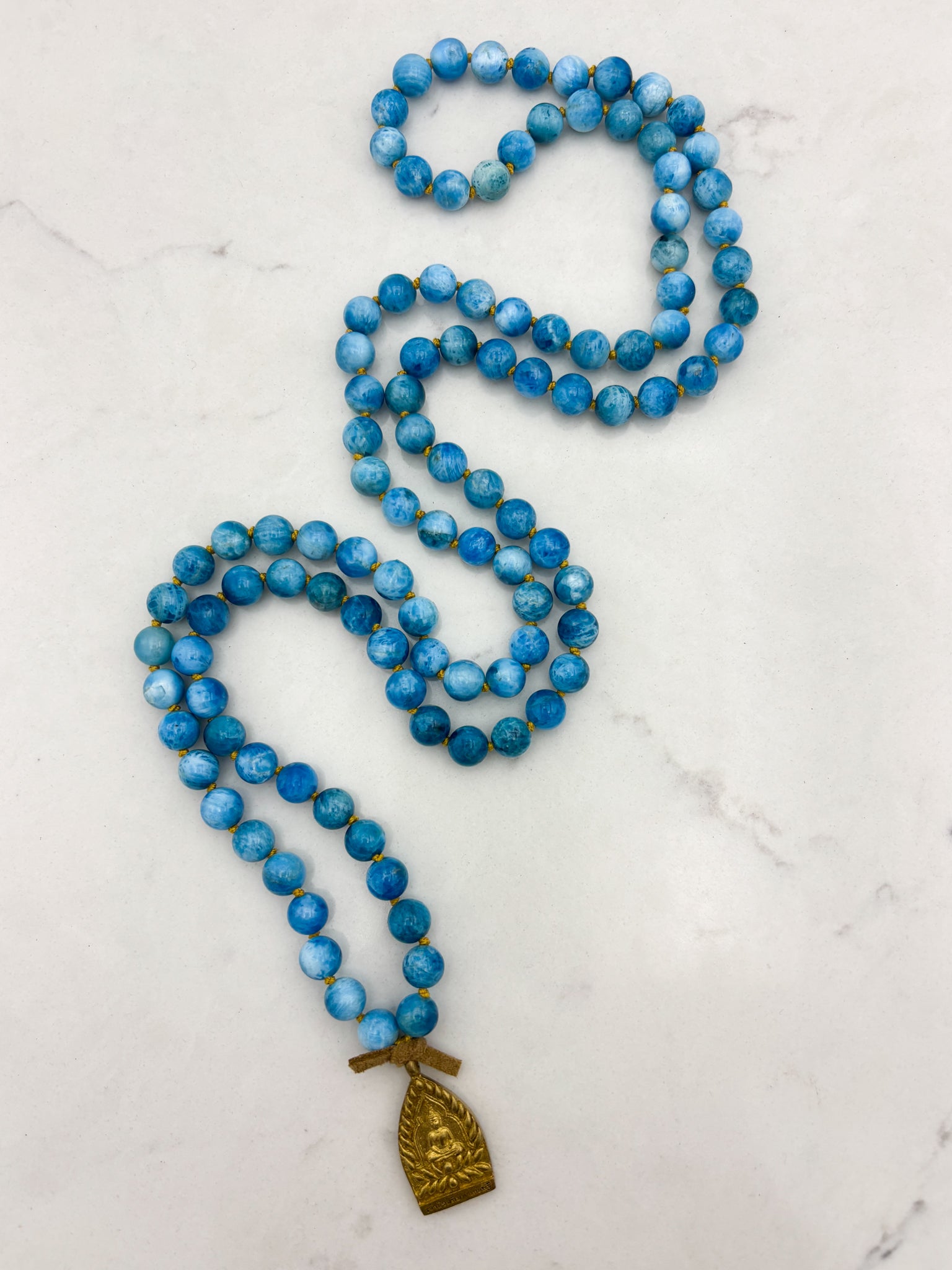 blue apatite gemstone mala with brass buddha pendant | radiant malas | handmade in boulder, colorado