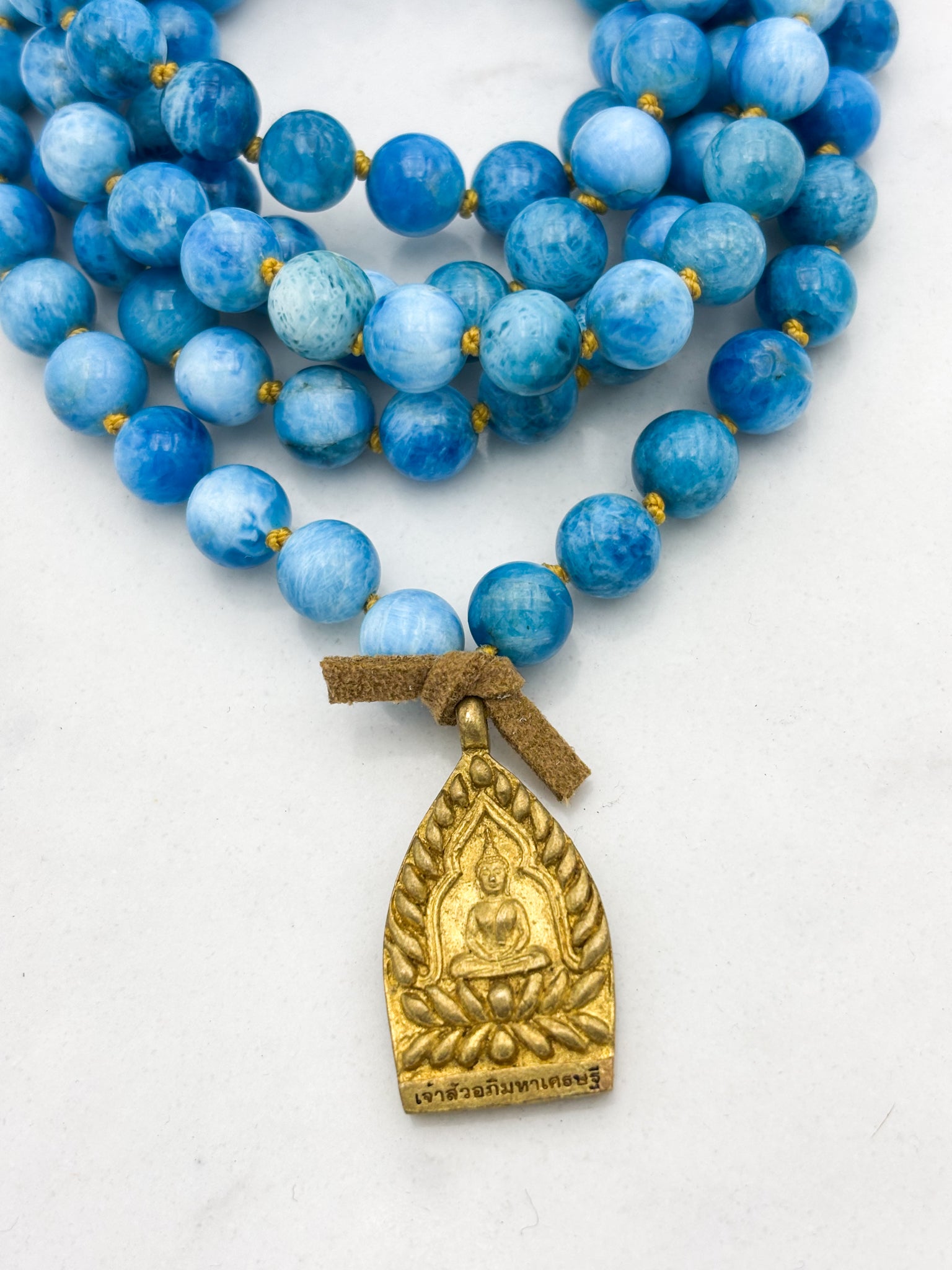 blue apatite gemstone mala with brass buddha pendant | radiant malas | handmade in boulder, colorado