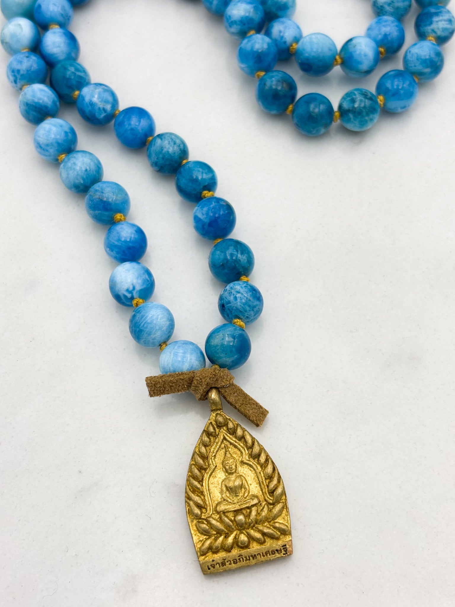 blue apatite gemstone mala with brass buddha pendant | radiant malas | handmade in boulder, colorado