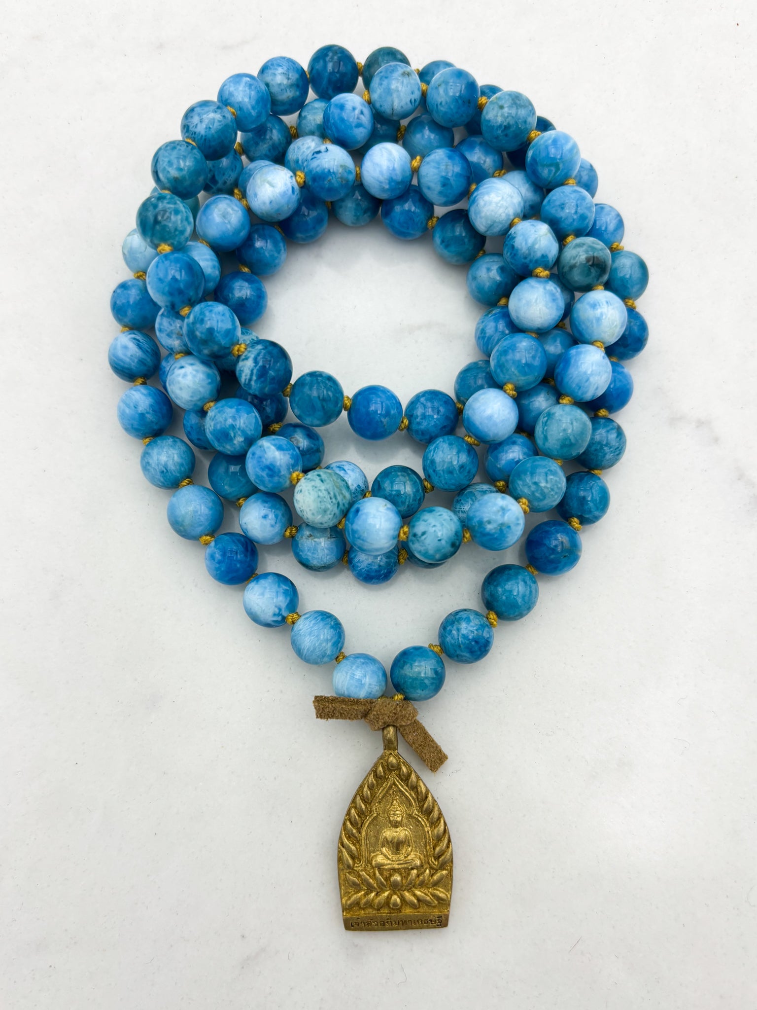 blue apatite gemstone mala with brass buddha pendant | radiant malas | handmade in boulder, colorado