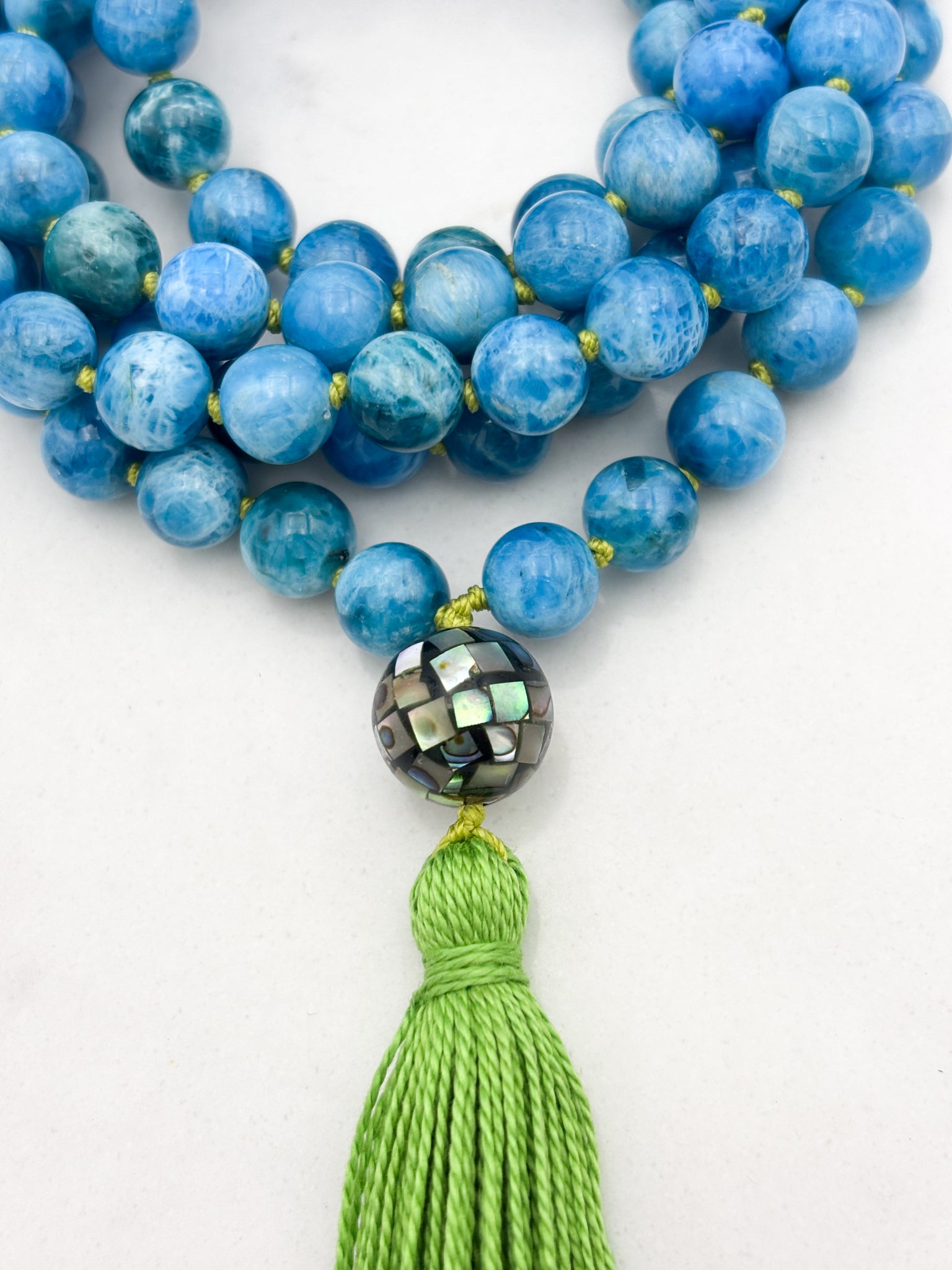 blue apatite gemstone mala with mosaic abalone shell guru bead and green tassel | radiant malas | handmade in boulder, colorado