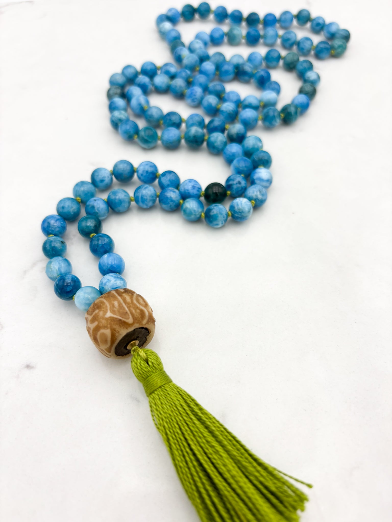 Blue Apatite gemstone mala with carved bone guru bead and green tassel | radiant malas | handmade in boulder, colorado