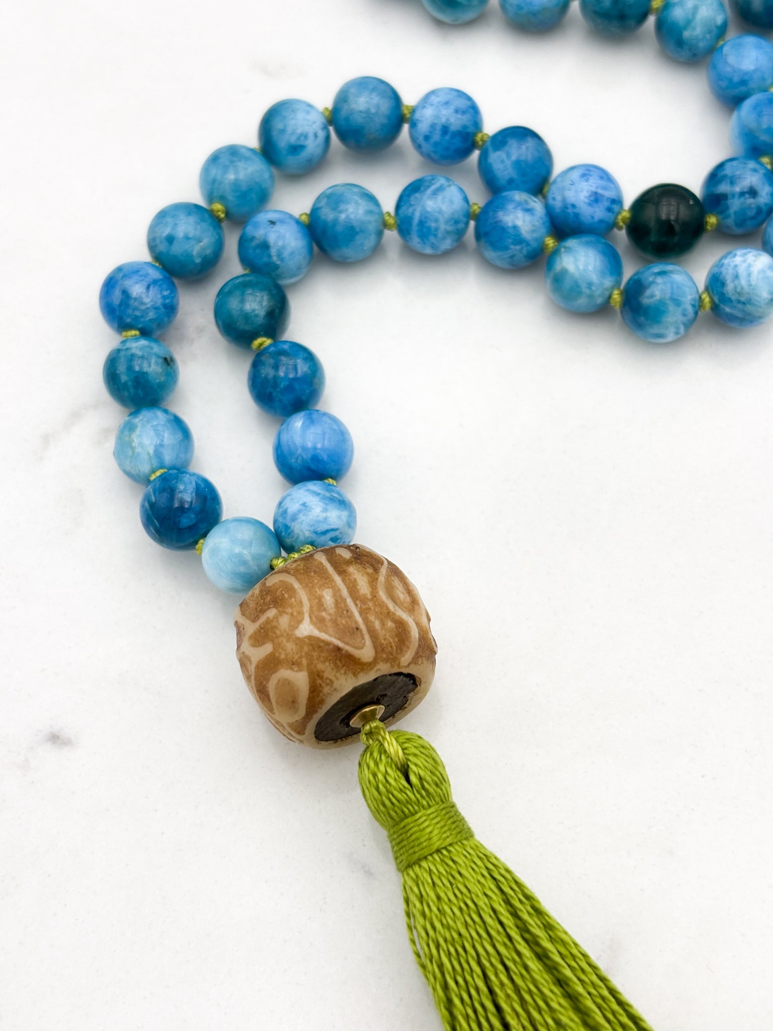 Blue Apatite gemstone mala with carved bone guru bead and green tassel | radiant malas | handmade in boulder, colorado