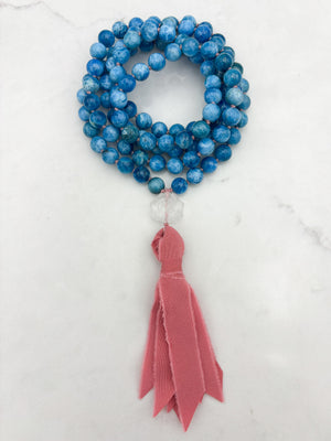 blue apatite gemstone mala with lotus-carved clear quartz guru bead and pinnk silk tassel | radiant malas | handmade in boulder, colorado