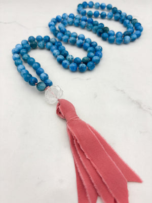 blue apatite gemstone mala with lotus-carved clear quartz guru bead and pinnk silk tassel | radiant malas | handmade in boulder, colorado
