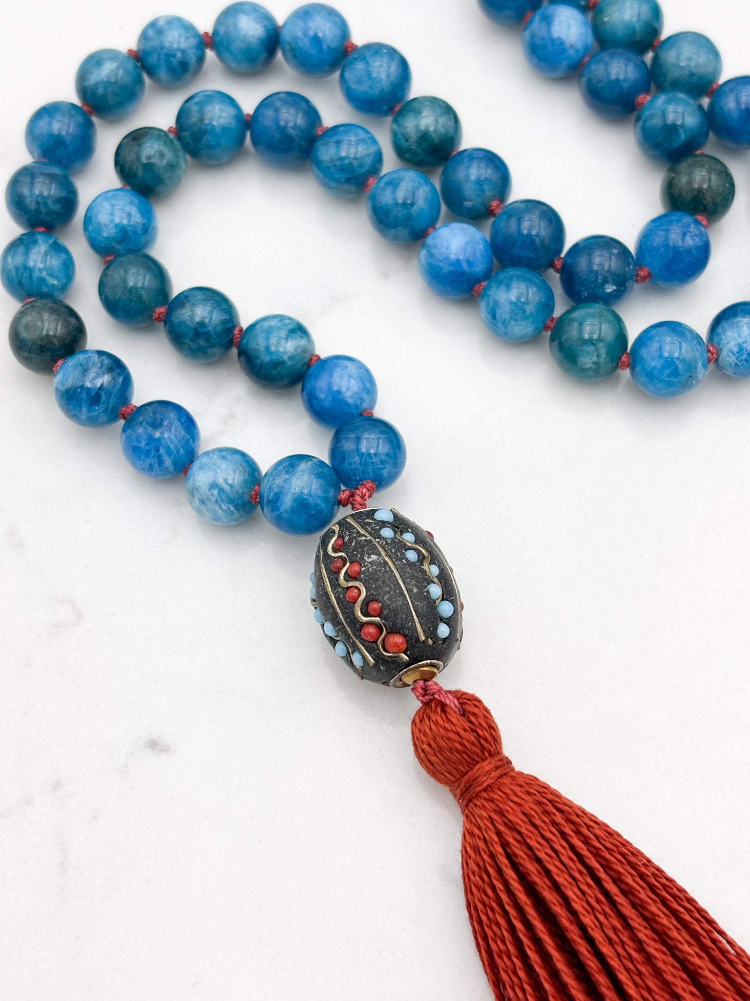 blue apatite gemstone mala necklace with Tibetan guru bead and rust tassel | radiant malas | handmade in boulder, colorado