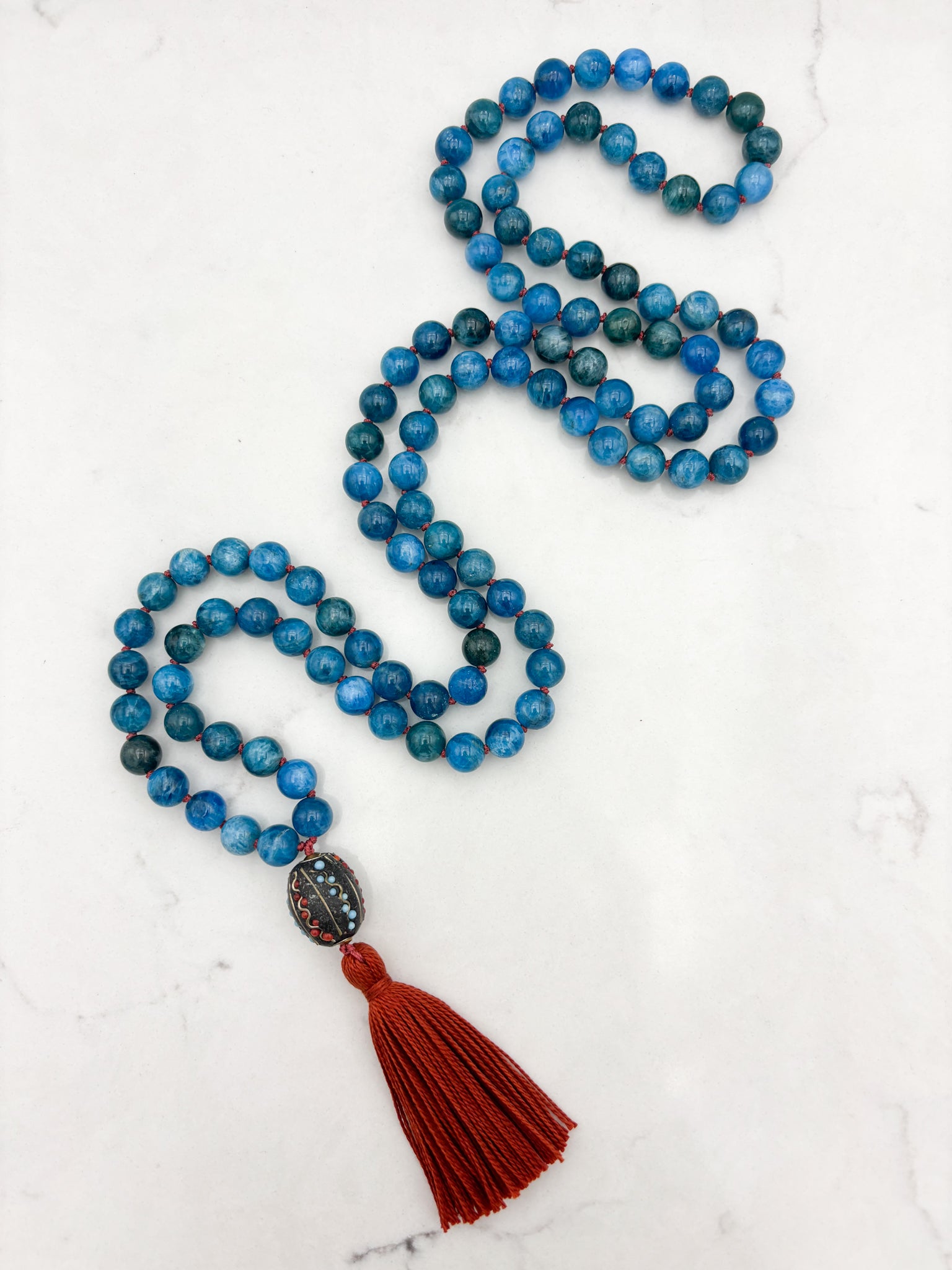 blue apatite gemstone mala necklace with Tibetan guru bead and rust tassel | radiant malas | handmade in boulder, colorado