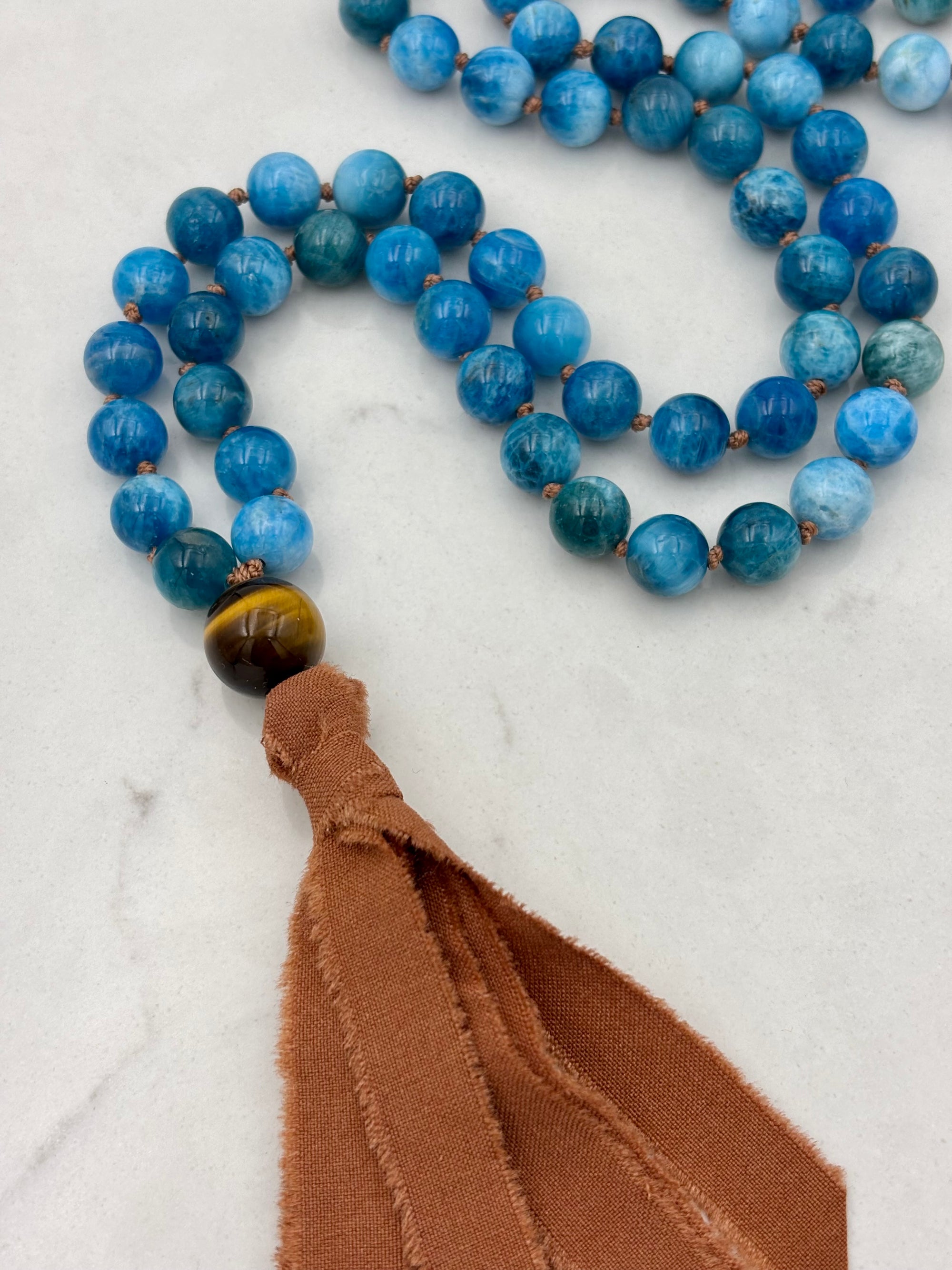 blue apatite gemstone mala with silk tassel | radiant malas | handmade in boulder, colorado