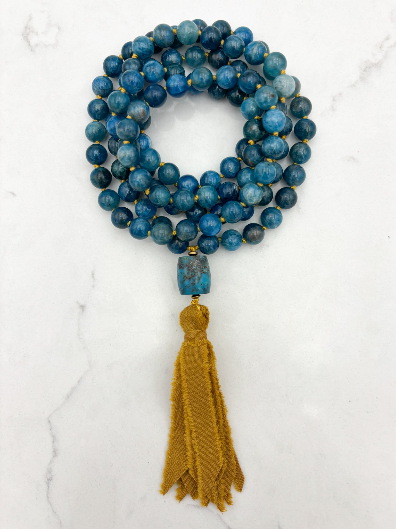 blue apatite gemstone mala with turquoise guru bead and ochre silk ribbon tassel | radiant malas | handmade in boulder, colorado