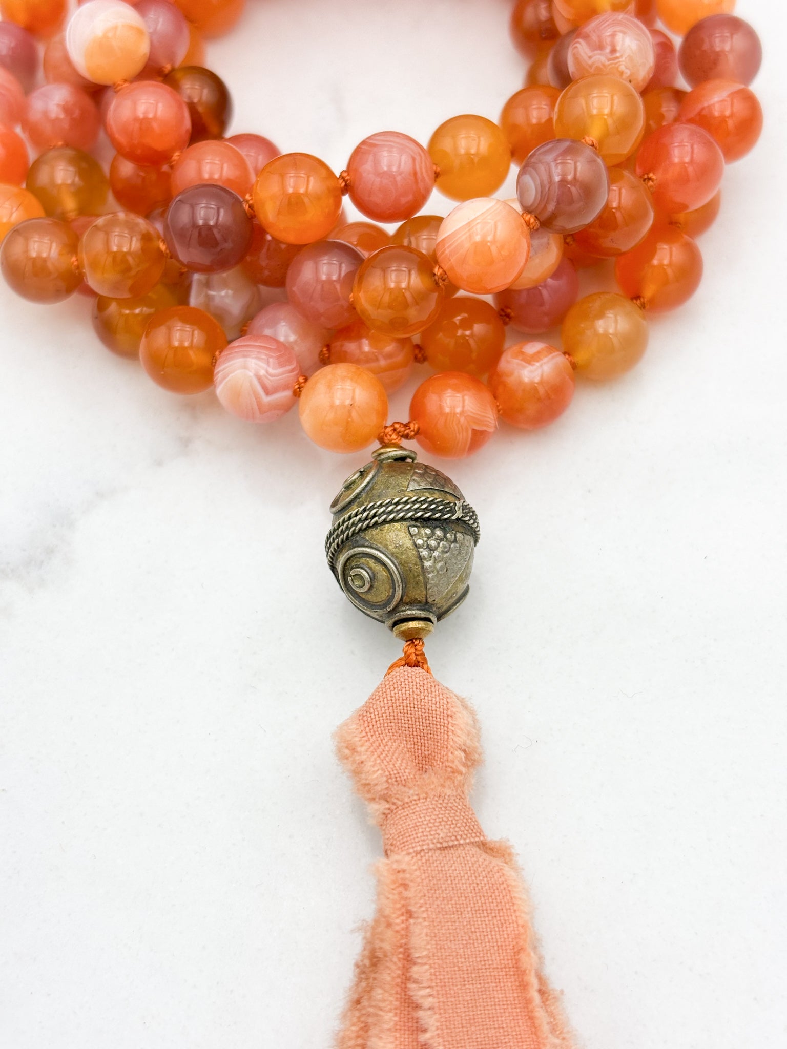 Red Botswana Agate Gemstone Mala with brass guru bead and peach silk tassel | radiant malas | handmade in Boulder, colorado
