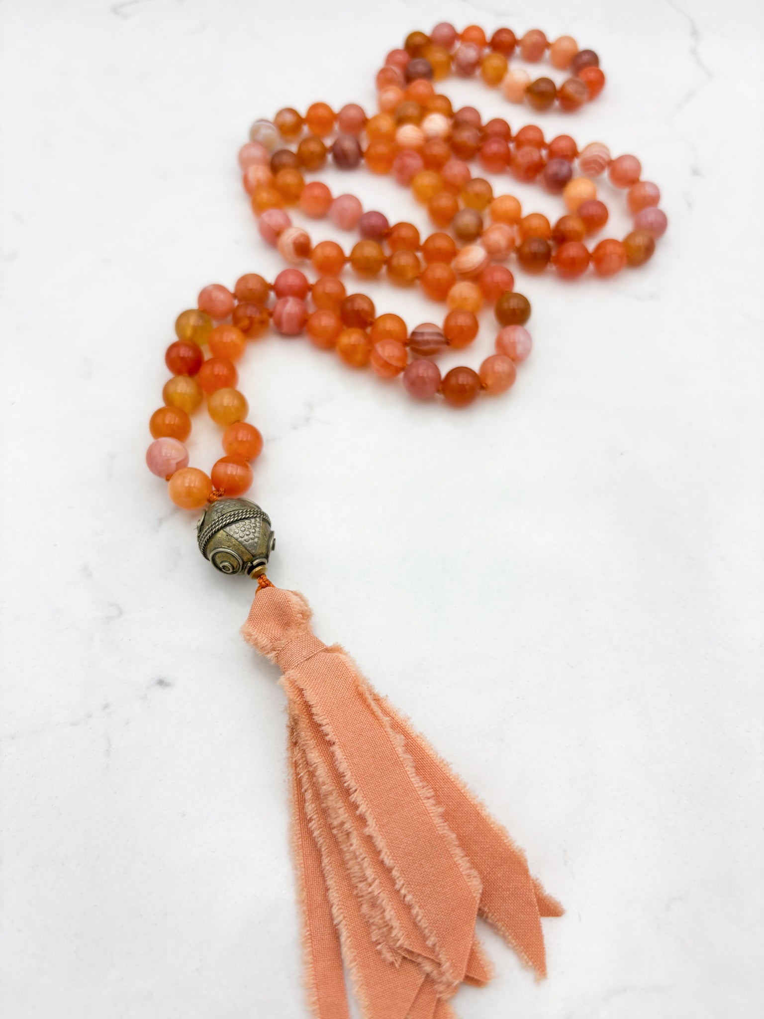 Red Botswana Agate Gemstone Mala with brass guru bead and peach silk tassel | radiant malas | handmade in Boulder, colorado