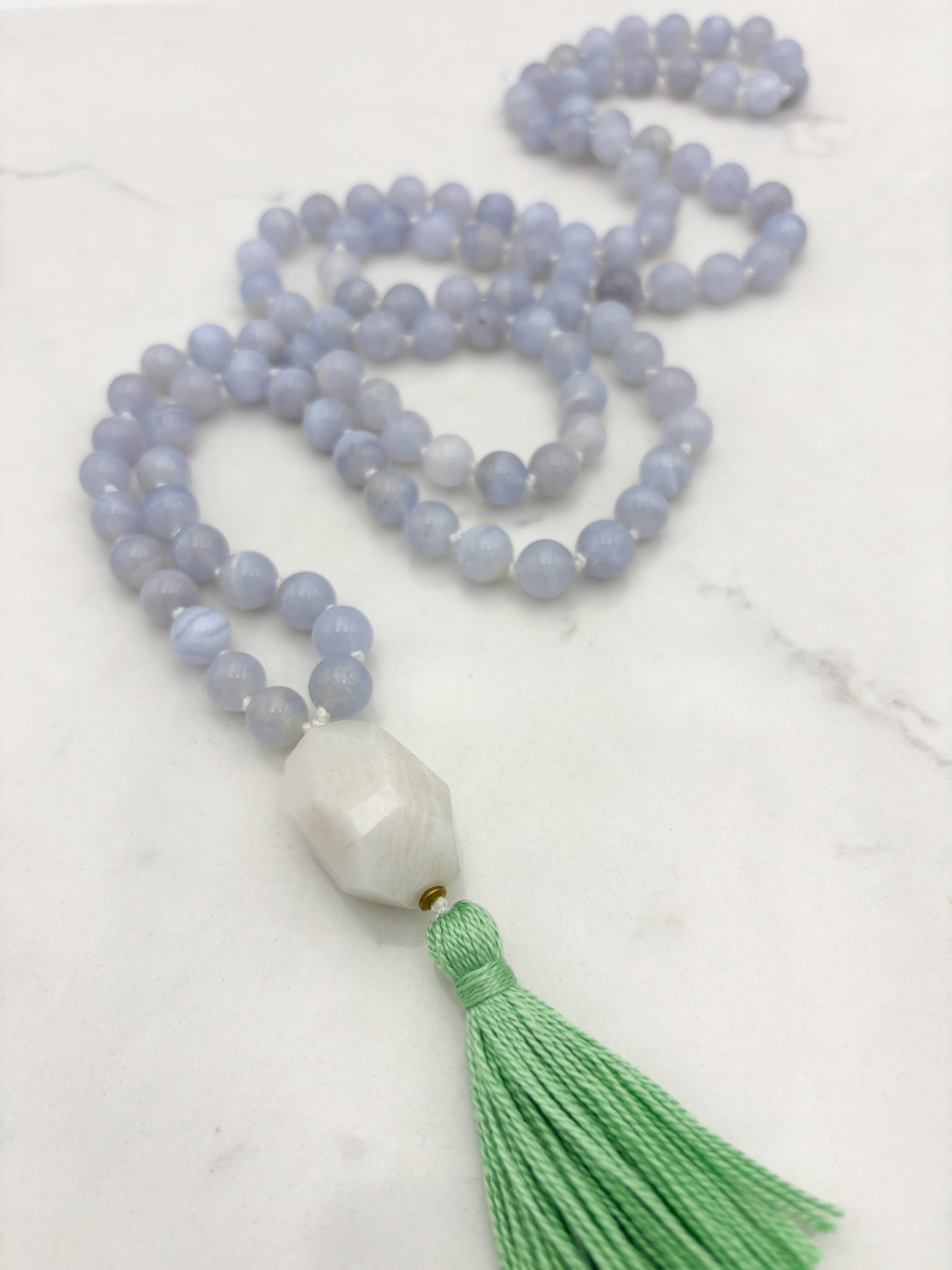 chalcedony gemstone mala with moonstone guru bead and green tassel | radiant malas | handmade in boulder, colorado