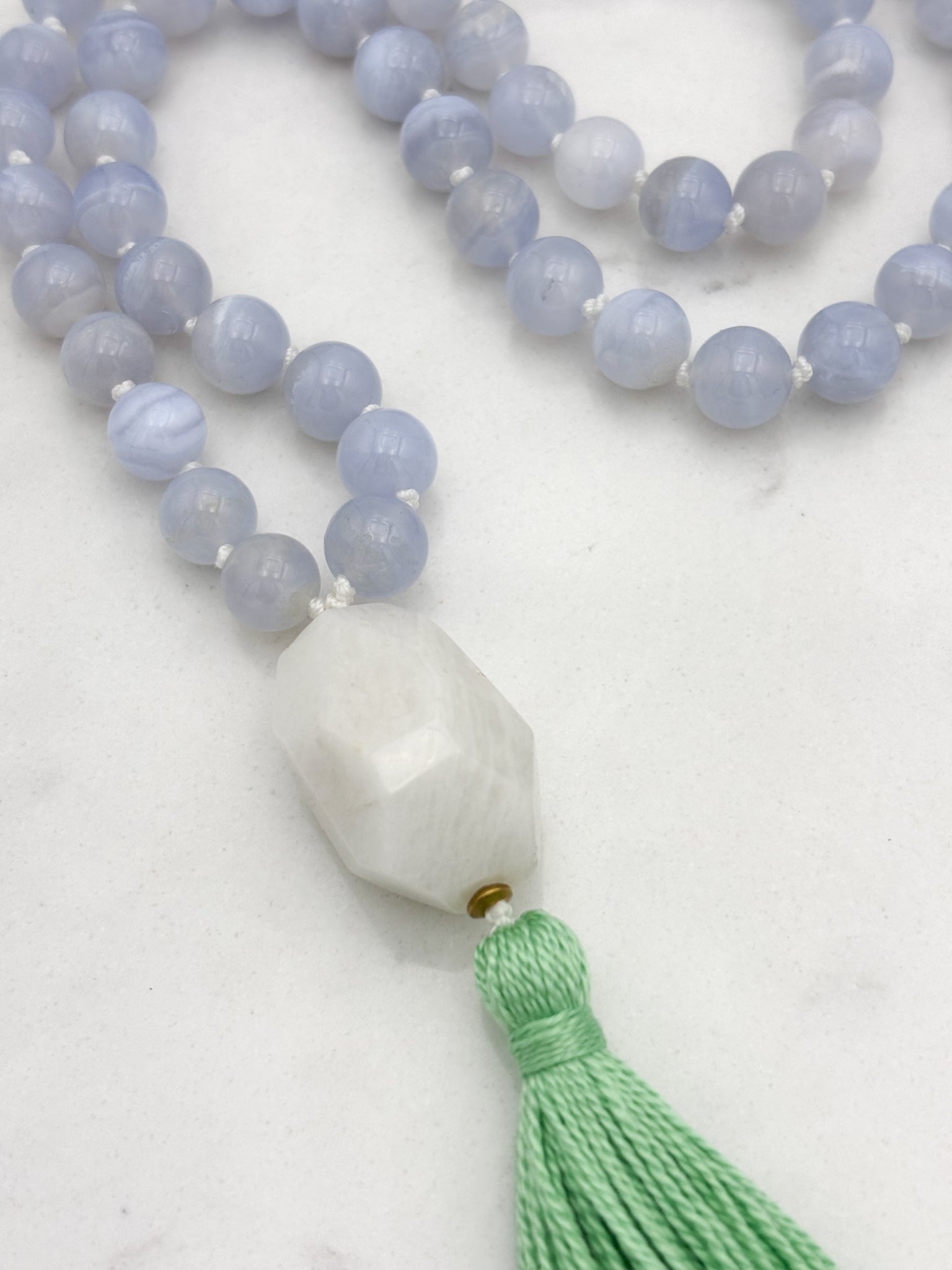 chalcedony gemstone mala with moonstone guru bead and green tassel | radiant malas | handmade in boulder, colorado