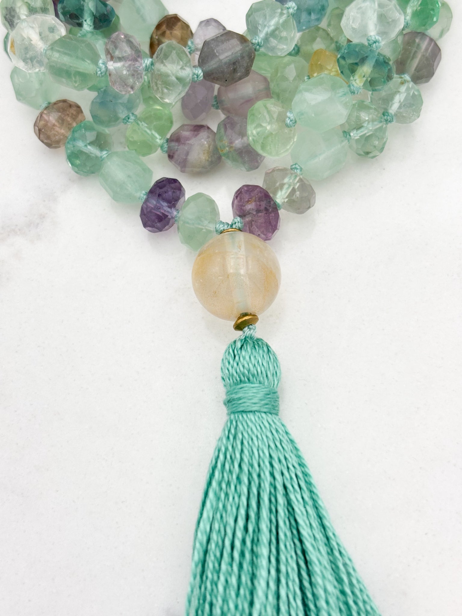 fluorite gemstone mala with golden quartz guru bead and mint green tassel | radiant malas  handmade in boulder, colorado