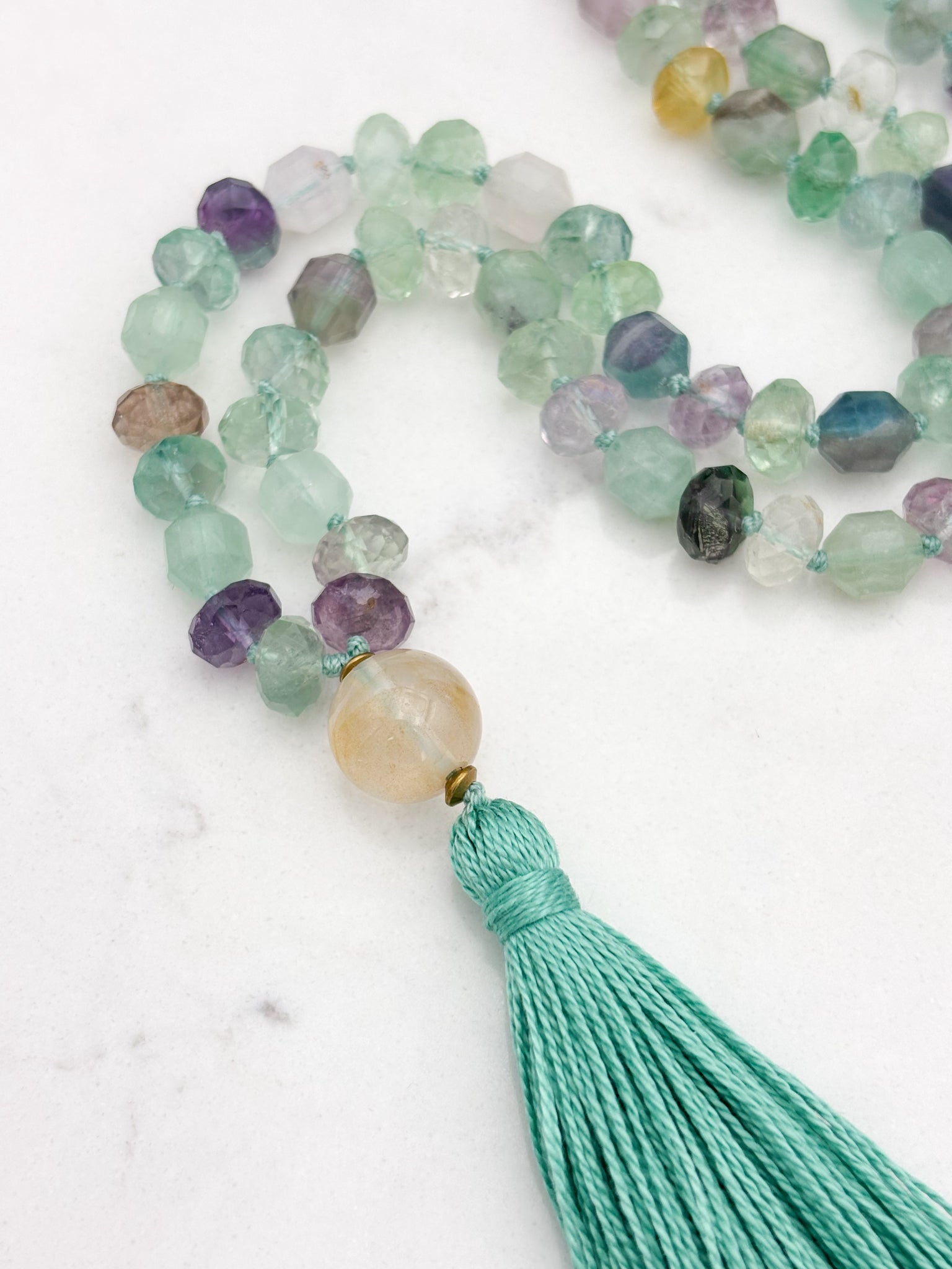 fluorite gemstone mala with golden quartz guru bead and mint green tassel | radiant malas  handmade in boulder, colorado
