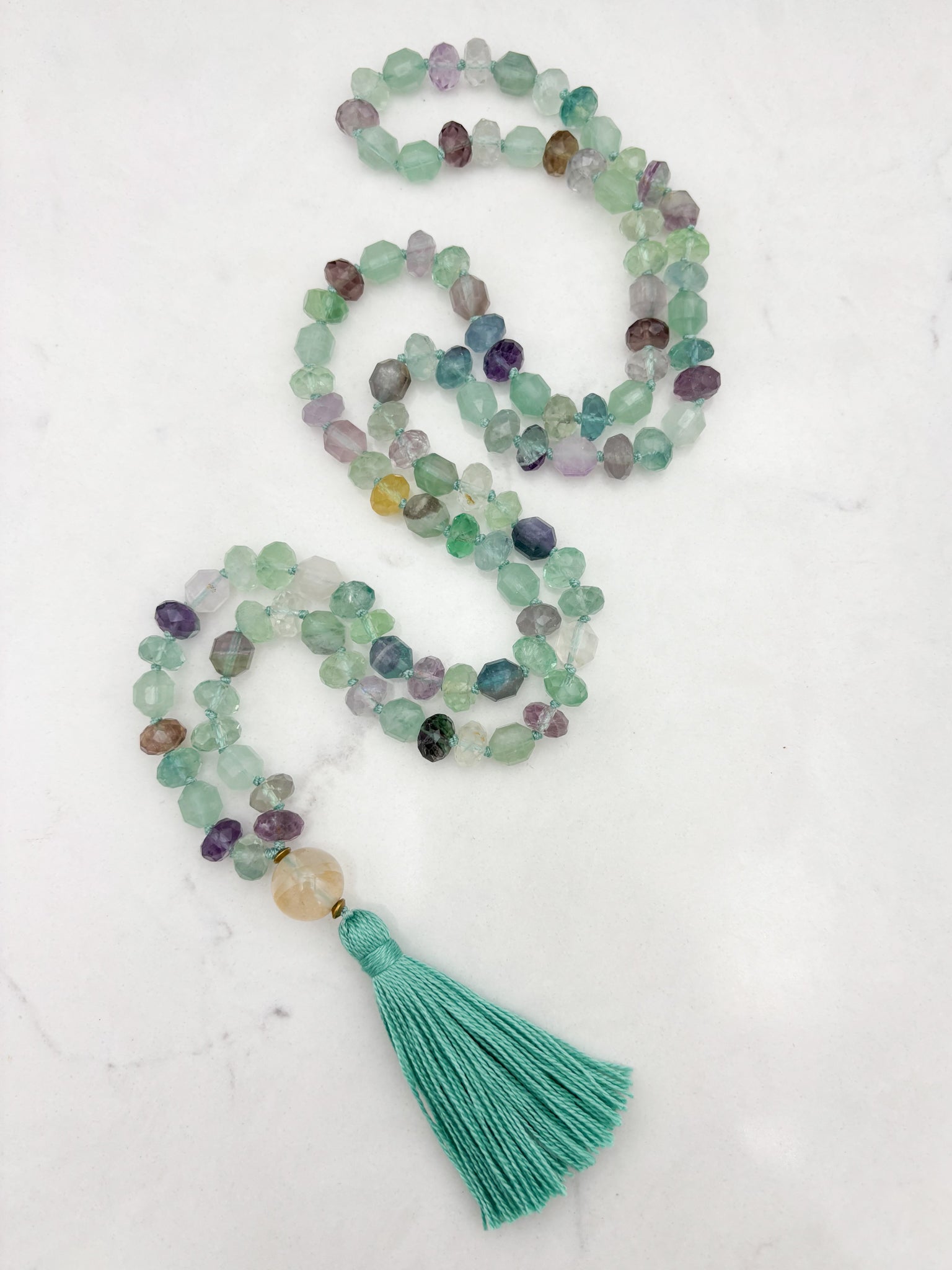 fluorite gemstone mala with golden quartz guru bead and mint green tassel | radiant malas  handmade in boulder, colorado