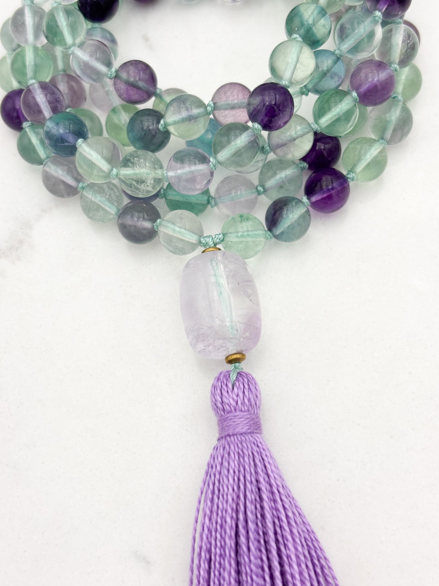 fluorite gemstone mala with amethyst guru bead and purple tassel | radiant malas  handmade in boulder, colorado